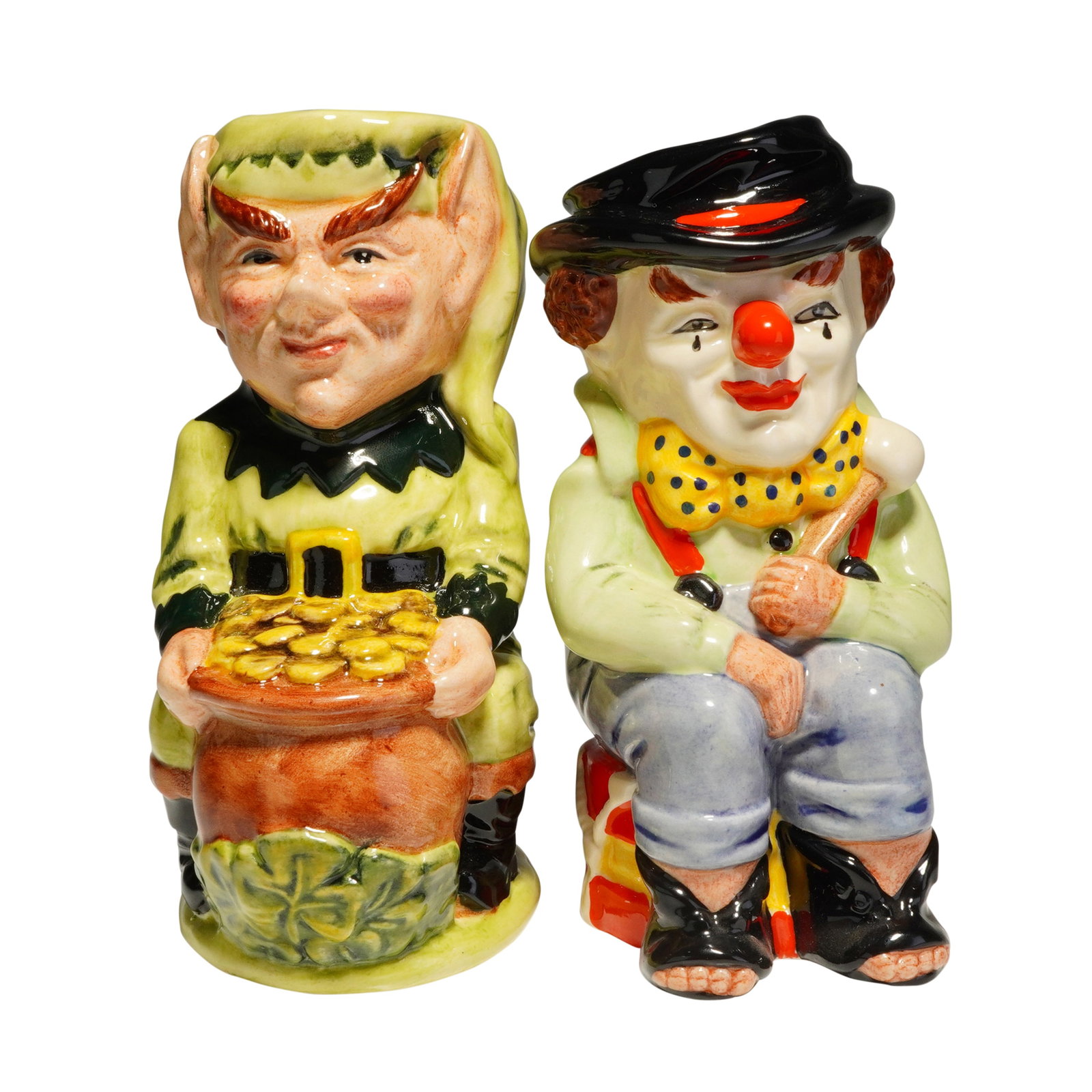 2pc Royal Doulton Toby Jugs, The Clown D6935 and Leprechaun D6948: Both jugs were modeled by Stanley James Taylor and issued as limited editions in the early 1990s. The Clown, a Royal Doulton Toby jug, features a seated carnival drummer with a mallet and drum, dated 