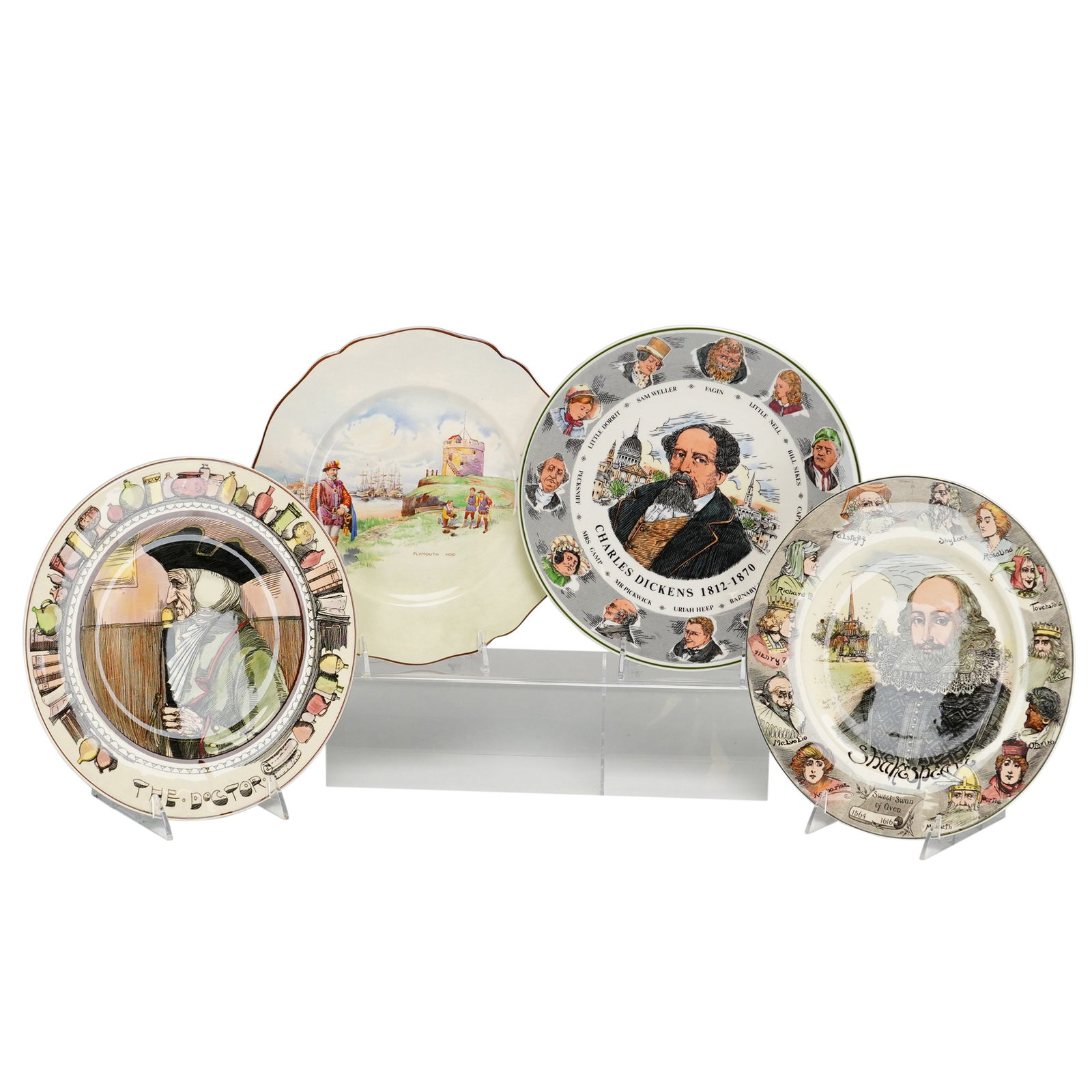 4pc Royal Doulton Decorative Ceramic Plates Featuring Shakespeare, Charles Dickens, and The Doctor: This group of four decorative ceramic plates is manufactured by Royal Doulton in England, utilizing earthenware and English Translucent China. The set includes a Shakespeare commemorative plate (D6303