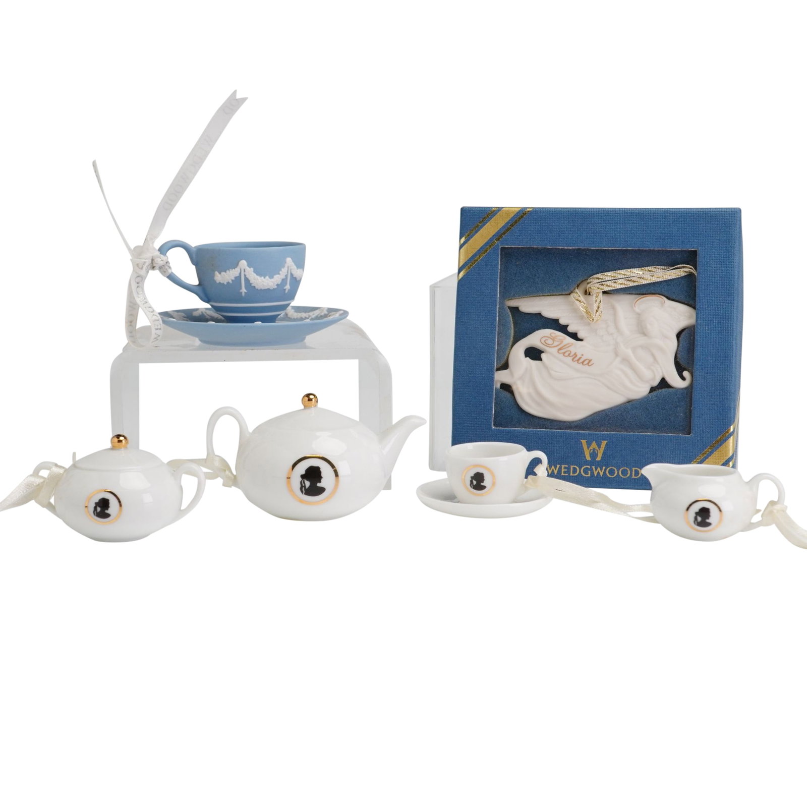 6pc Wedgwood Miniature Tea Ornaments: Wedgwood group of six miniature ceramic ornaments including a four-piece silhouette tea set, a jasperware teacup and saucer, and an angel figure. The silhouette set is crafted from white glazed porcel