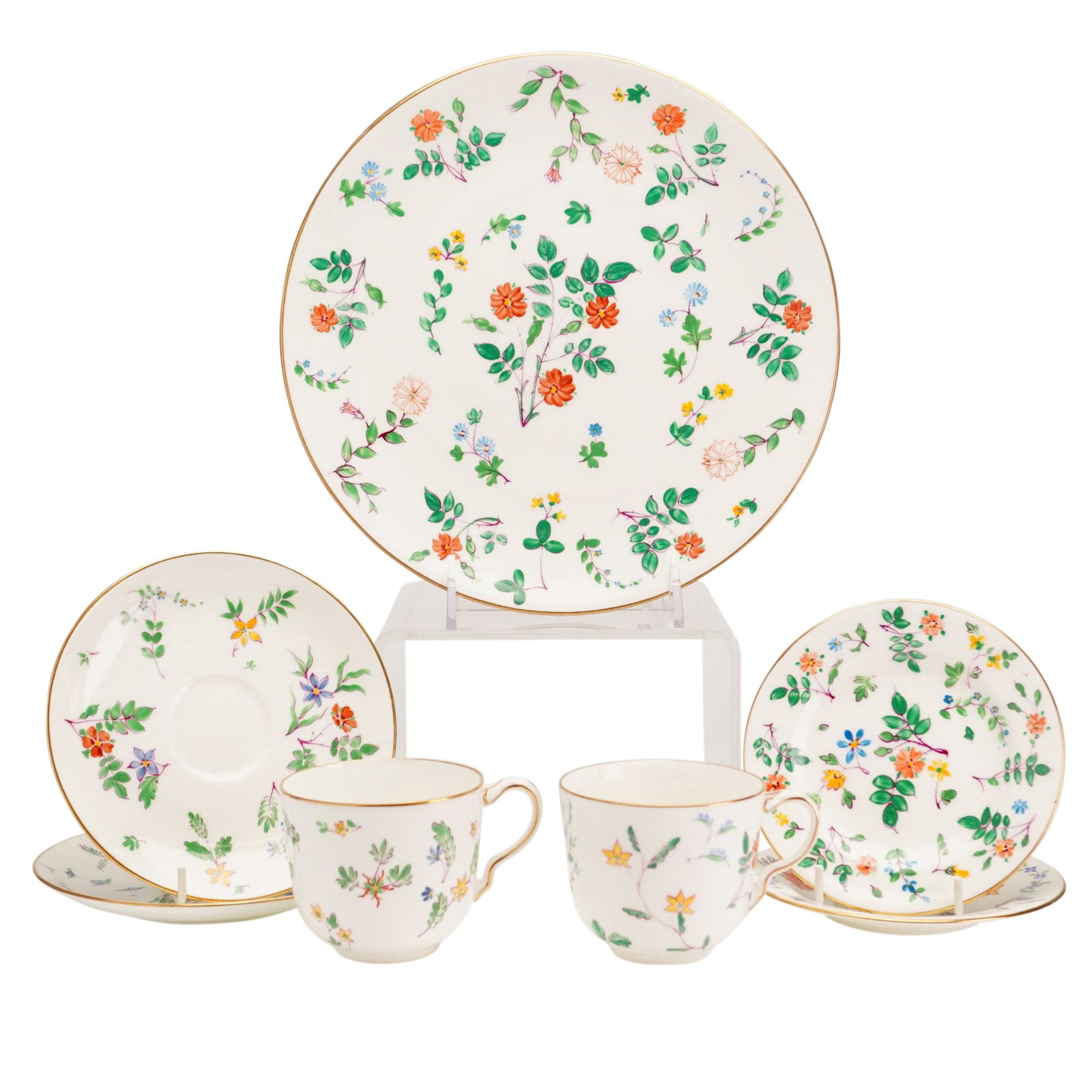 7pc Wedgwood Porcelain Dessert and Tea Wares: A set of fine porcelain dessert and tea wares by Wedgwood, England, featuring the hand painted floral Pattern 1823. The set includes one large circular plate or charger, two teacups, and four saucers.