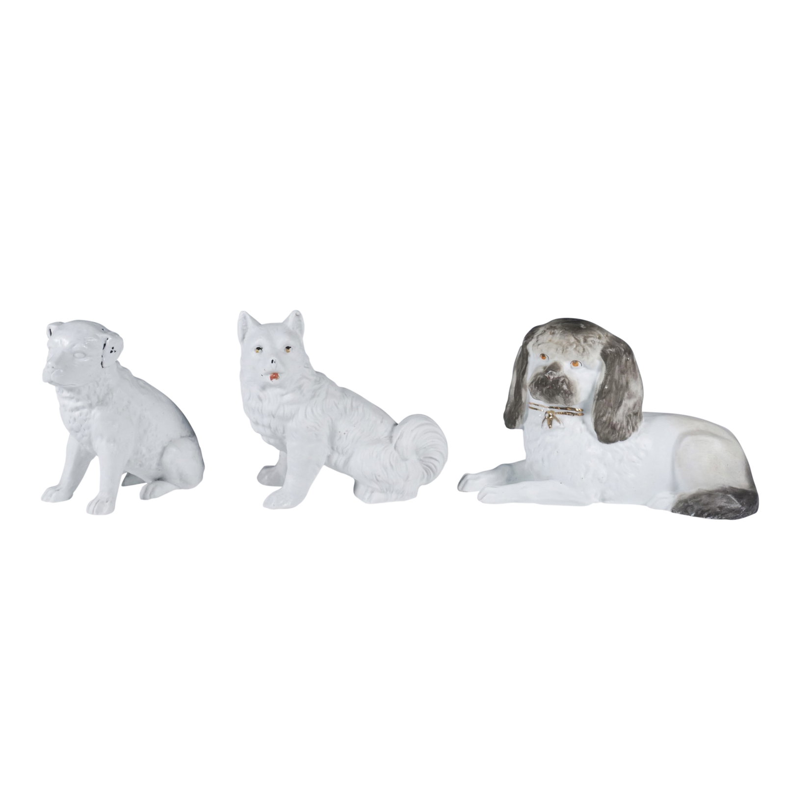 3pc Seated and Reclining Porcelain Dog Figurines: A set of three porcelain dog figurines, each uniquely crafted with fine detailing and hand-painted accents. The set includes a seated dog with black and gold highlights, a fluffy-tailed canine with su