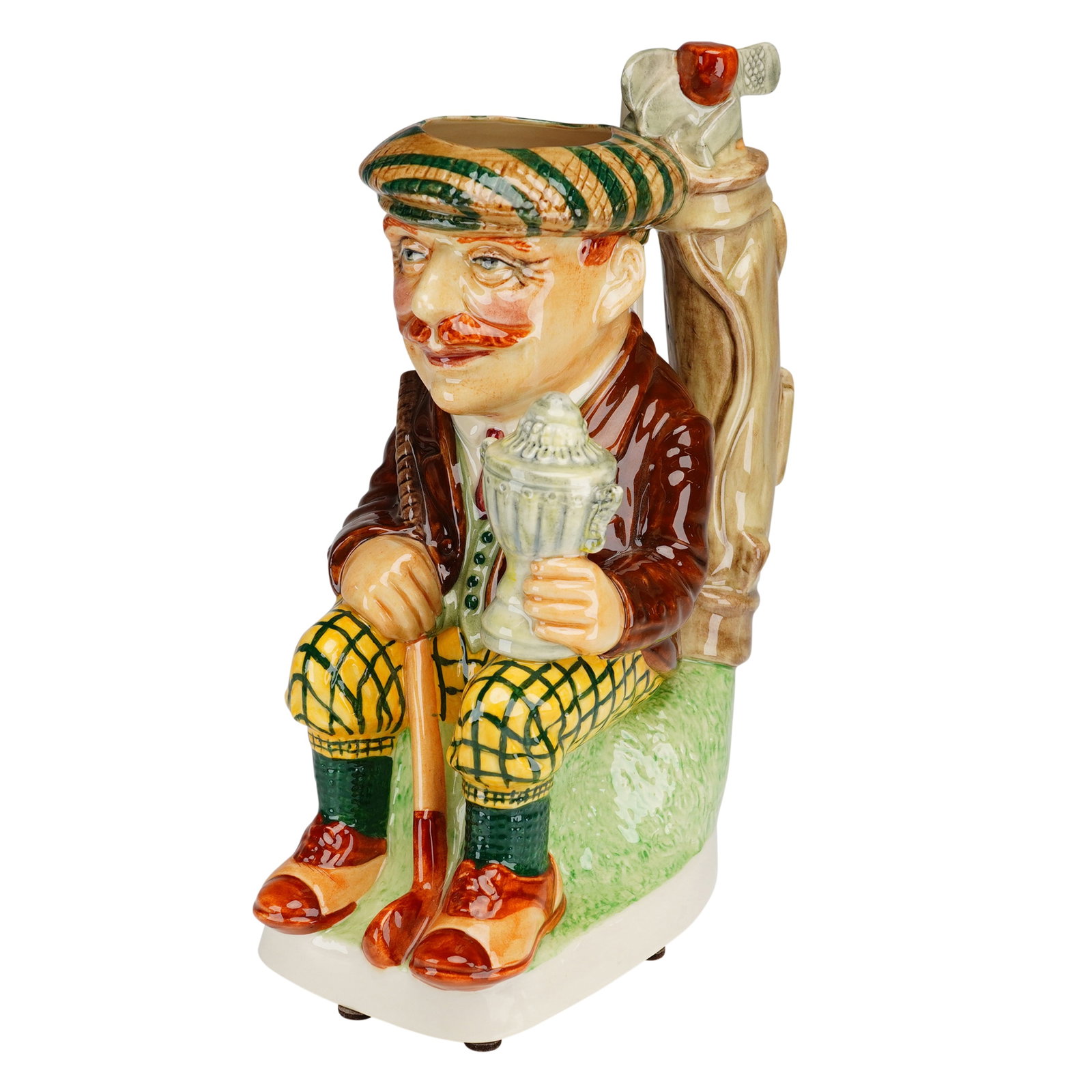 Kevin Francis Ceramics Limited Edition Toby Jug, The Golfer with COA: The molded ceramic figure depicts a seated golfer in traditional attire, including a green and tan striped flat cap, a brown jacket over a green vest and red tie, and yellow plaid knickerbockers. The 