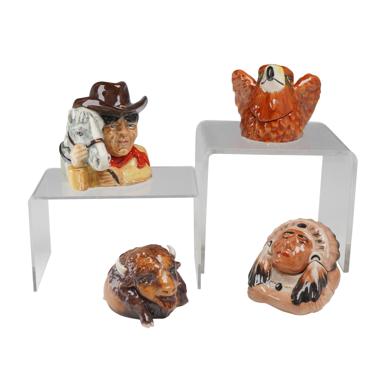 4pc Kevin Francis Face Pots, Western Theme Group: A group of four hand-painted glazed ceramic miniature lidded vessels, known as Face Pots, produced by Kevin Francis in England. Each pot features a themed lid and base with a unique interior inscripti