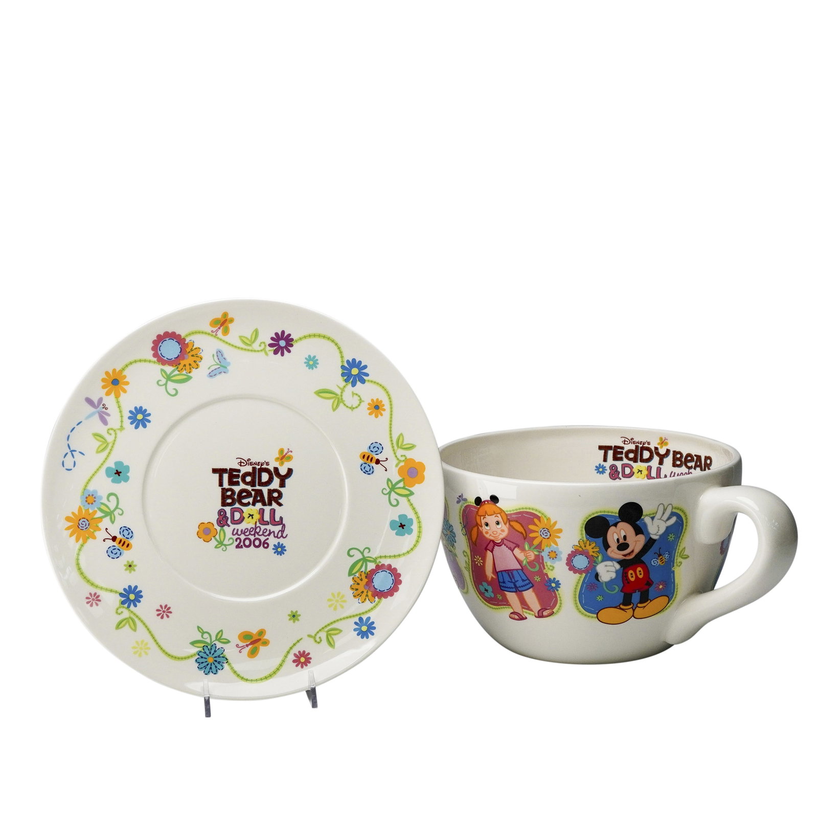 Disney Teddy Bear & Doll Weekend 2006 Oversized Decorative Cup and Saucer: Commemorating Disney's Teddy Bear & Doll Weekend 2006, this oversized decorative cup and saucer set features vibrant floral artwork with Mickey Mouse and a young girl in cheerful celebration. The colo