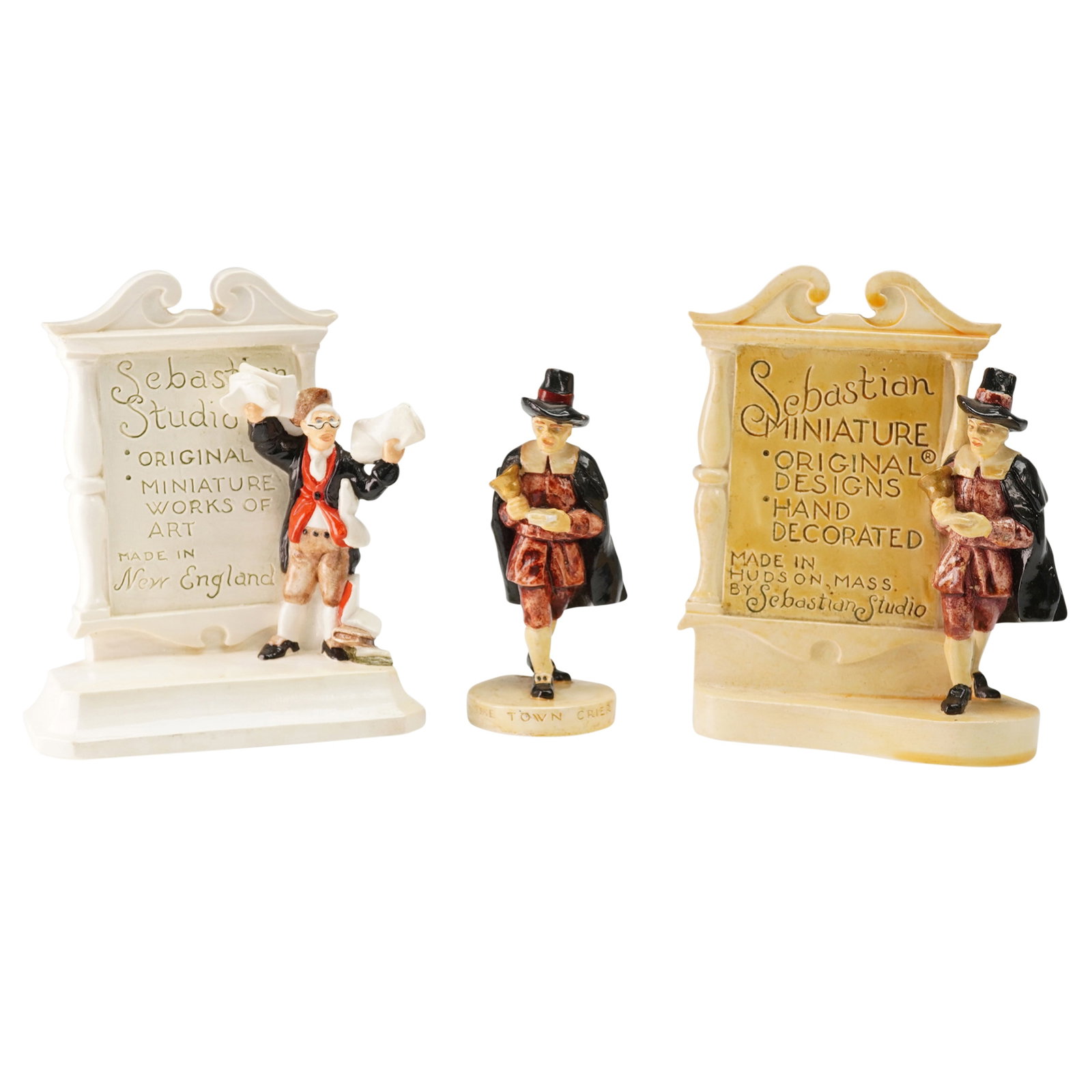3pc Sebastian Miniatures Figurine and Dealer Advertising Plaques: Grouping of three hand-cast and hand-painted Sebastian Miniatures including one figure titled The Town Crier along with two dealer advertising plaques. Each plaque bears the company name and inscripti
