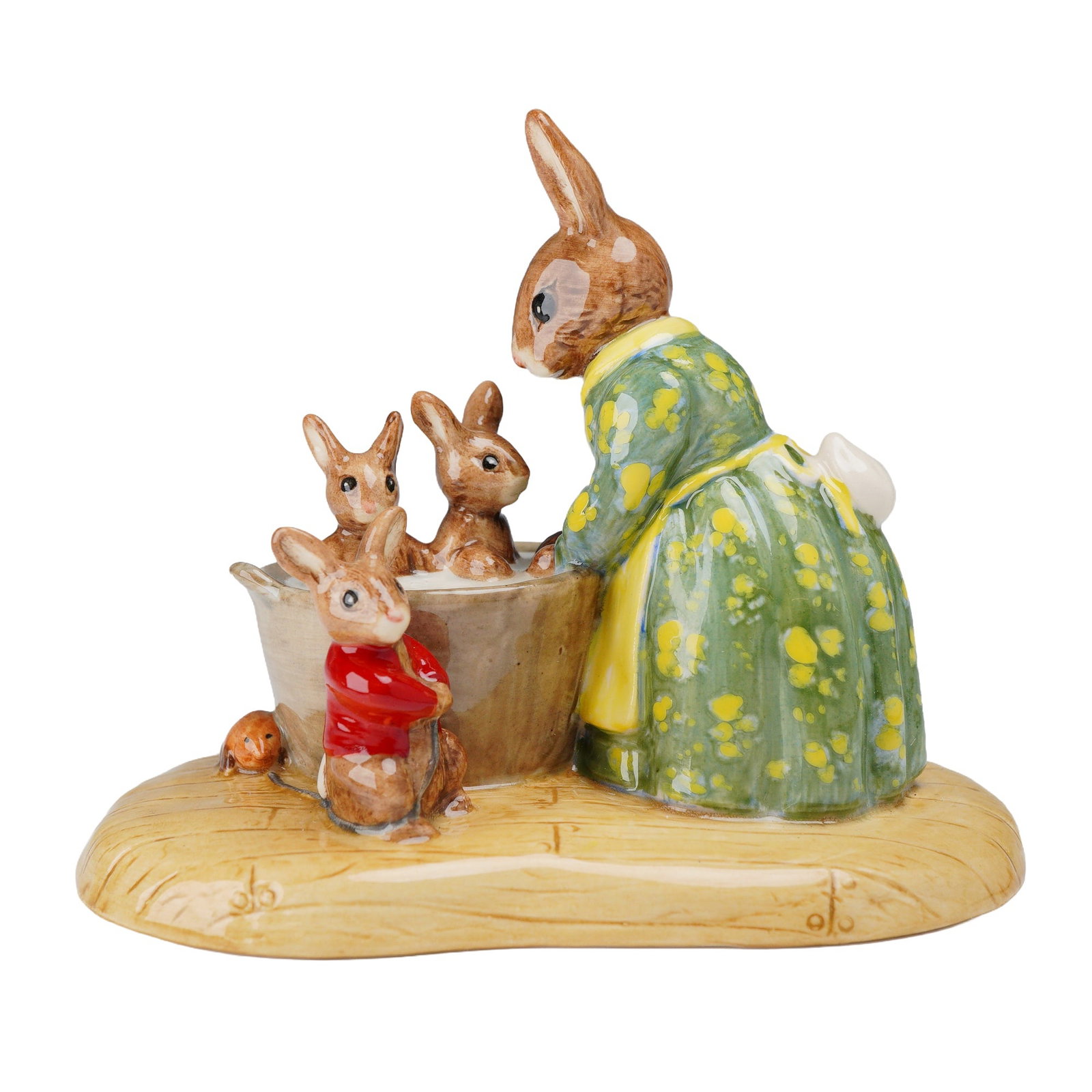 Royal Doulton Rare Prototype Bunnykins Bathnight Figurine: This Royal Doulton glazed bone china figurine is a rare prototype of the Bunnykins Bathnight tableau. The scene depicts Mrs. Rabbit wearing a green floral-patterned dress and a yellow apron while bath
