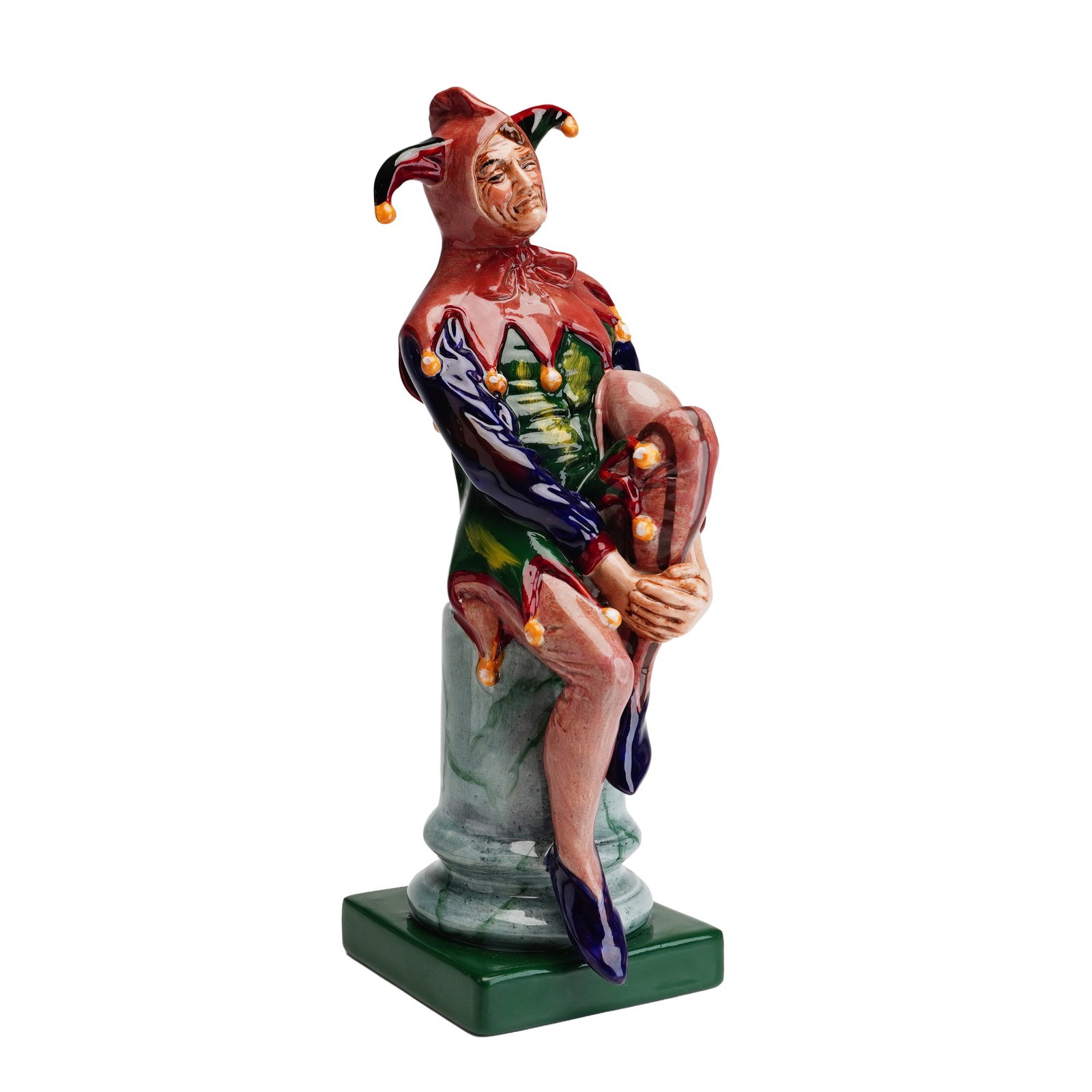 Royal Doulton Artists Copy Figurine with Rare Bottle Green Base, The Jester HN2016: This Royal Doulton porcelain figurine is titled The Jester, model number HN2016. The figure is depicted in a traditional three-pointed jester's hat with bells, wearing a vibrant multi-colored tunic in