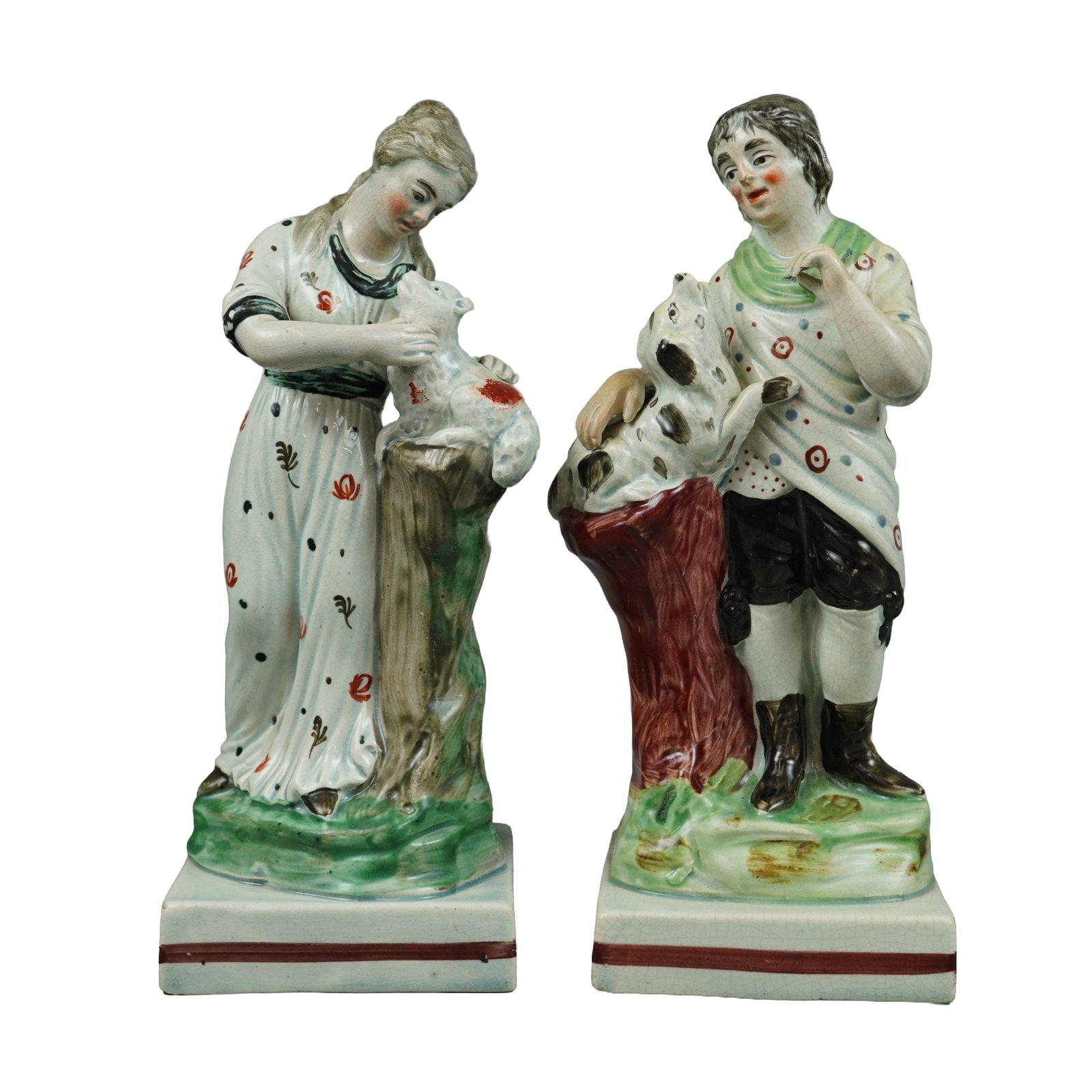 2pc Wedgwood Pearlware Pastoral Figurines: This lot consists of a pair of early 19th-century lead-glazed earthenware figurines from the 2pc Lenhart collection, identified as pearlware by the bluish tint in the glaze. The first figure depicts a