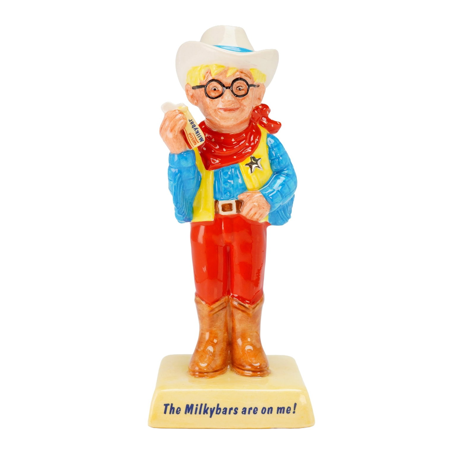 Royal Doulton Advertising Figurine, The Milkybar Kid AC7: A limited edition example depicting a blonde-haired boy wearing spectacles and dressed as a western sheriff, with red pants, a blue shirt, and a yellow vest fitted with a silvery sheriff badge, along 
