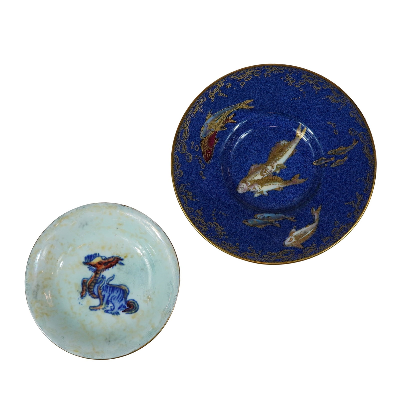 2pc Wedgwood Fairyland Lustre Saucer and Baku Pin Dish: This lot features two early 20th-century bone china saucers manufactured by Wedgwood and designed by Daisy Makeig-Jones. Pin dish is decorated in the Dragon Luster pattern Baku with a mottled iridesce