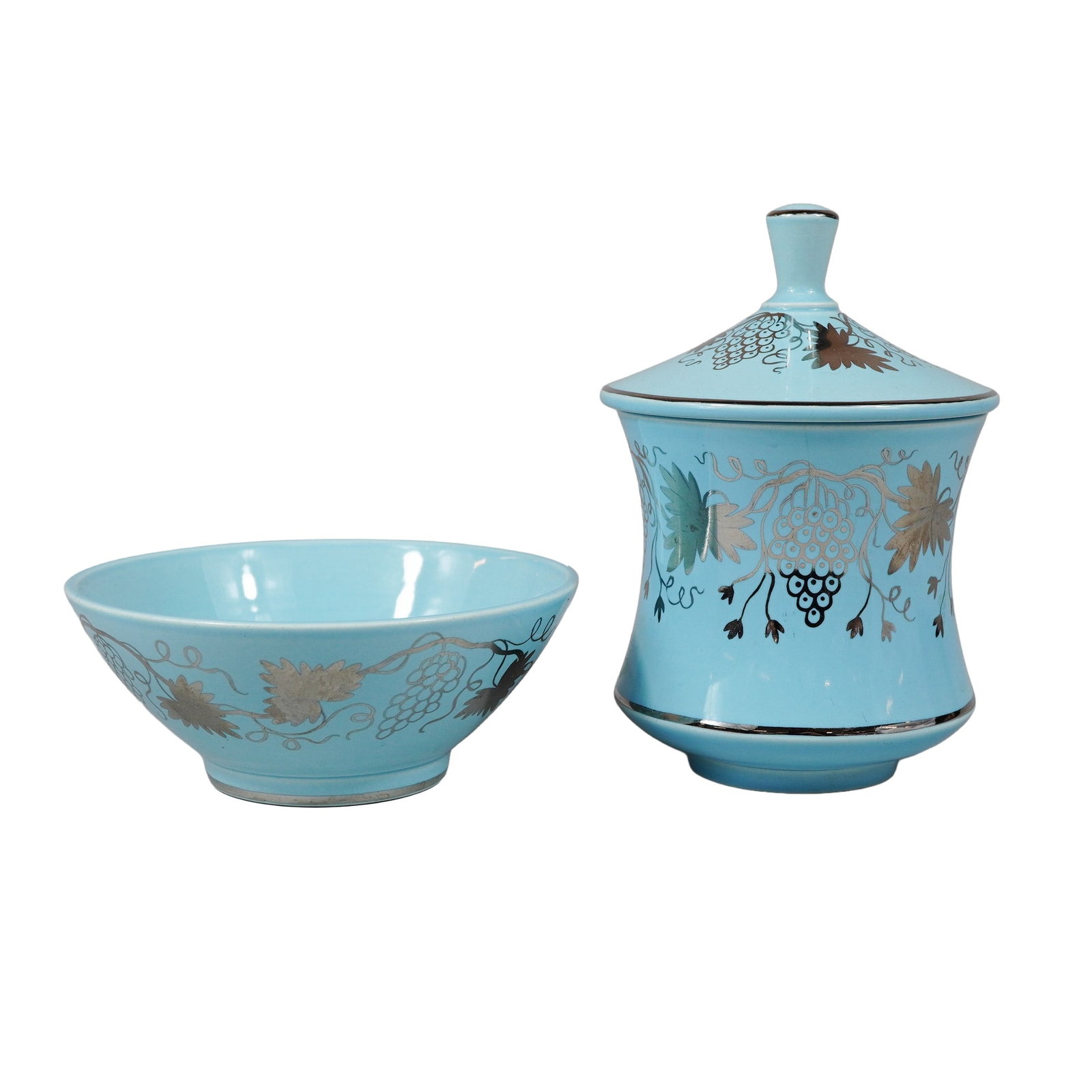 Pair of Wedgwood Norman Wilson Turquoise and Platinum Luster Grapevine Motif Bowl and Jar: This two-piece set includes a lidded jar and a matching open bowl manufactured by Wedgwood in England. The pieces are crafted from fine earthenware and finished with a vibrant turquoise blue glaze. Th