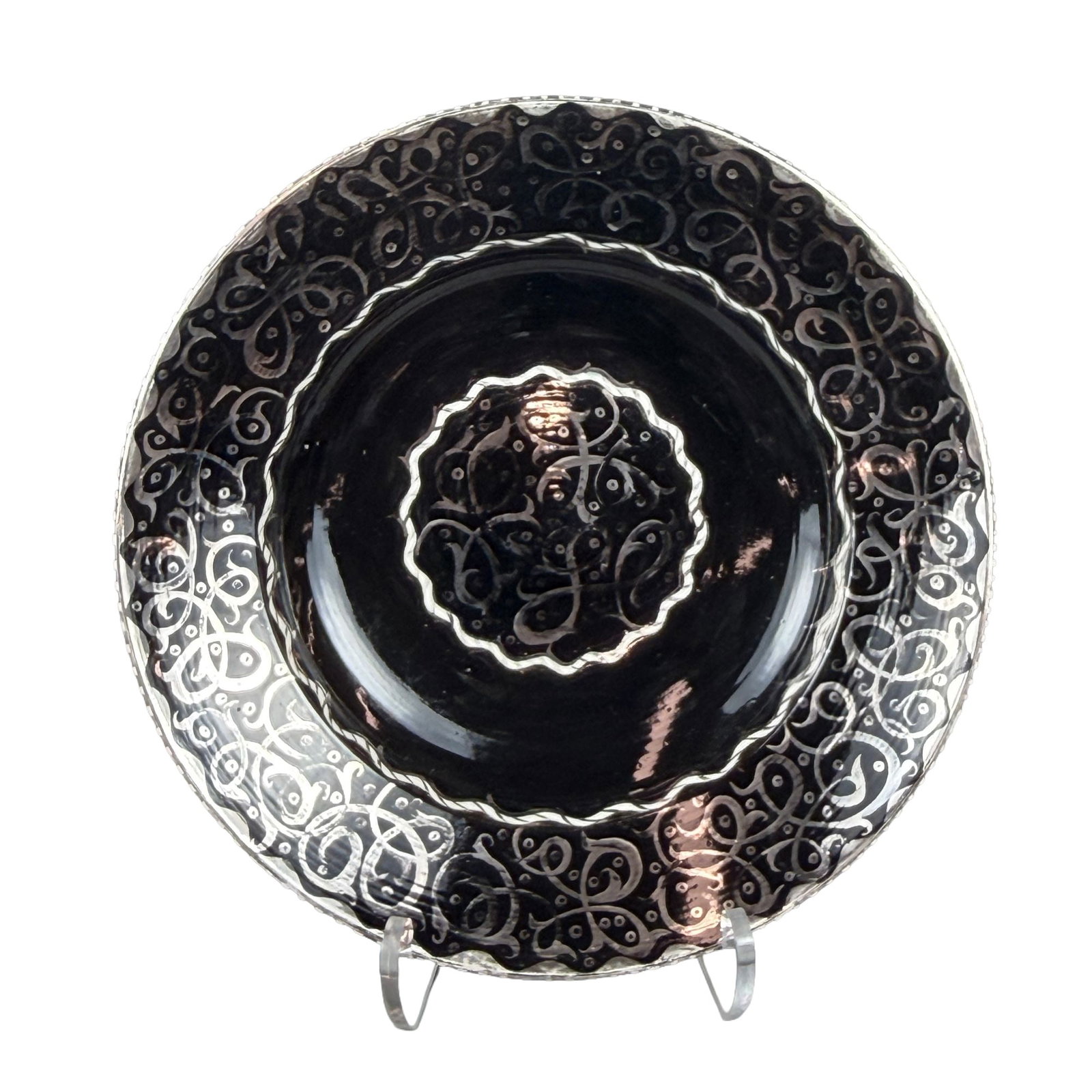 Large Wedgwood Silver Luster Decorated Earthenware Charger by Alfred and Louise Powell: A large glazed earthenware charger manufactured by Wedgwood and hand-decorated by Alfred and Louise Powell. The piece features a shallow circular form with a wide rim and a recessed central well. The 