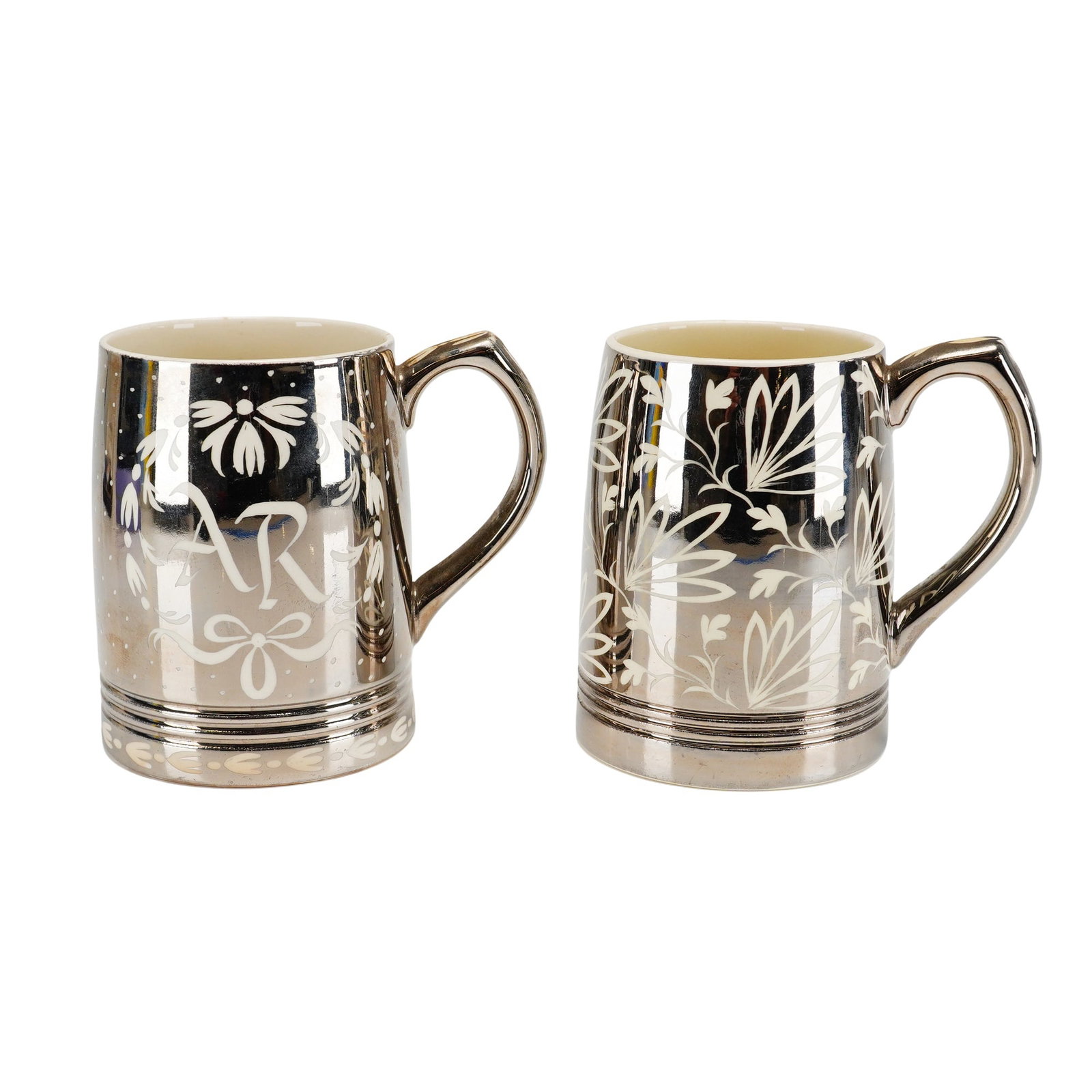 2pc Keith Murray for Wedgwood Platinum Luster Earthenware Mugs: This pair of tapered cylindrical earthenware mugs was designed by Keith Murray for Wedgwood and features silver resist decoration. Each mug is constructed with a looped handle and a triple-ribbed base