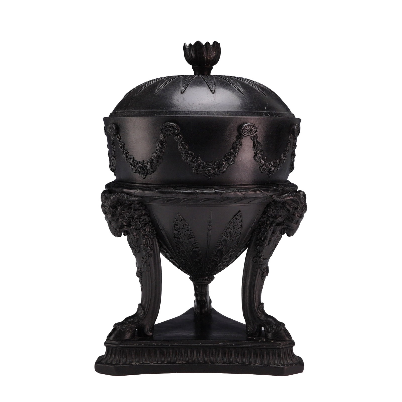 Wedgwood Black Basalt Tripod Vase and Cover: A Wedgwood black basalt tripod amphora vase and cover. This neoclassical form is crafted from unglazed black stoneware. The domed lid features a flower-bud finial and is decorated with molded radial p