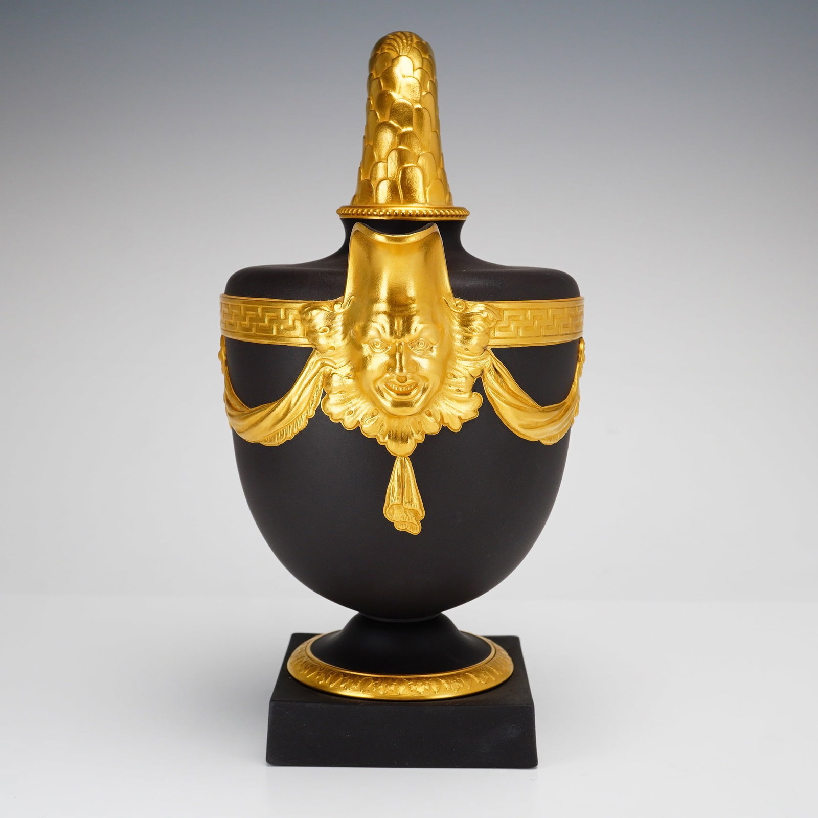 Wedgwood Limited Edition Black Basalt and Gilded Fishtail Ewer: A Wedgwood black basalt and gilded stoneware ewer of neoclassical form, produced in 1998 as part of a limited edition based on an original 17th-century design by Jacques Stella. The vessel is crafted 