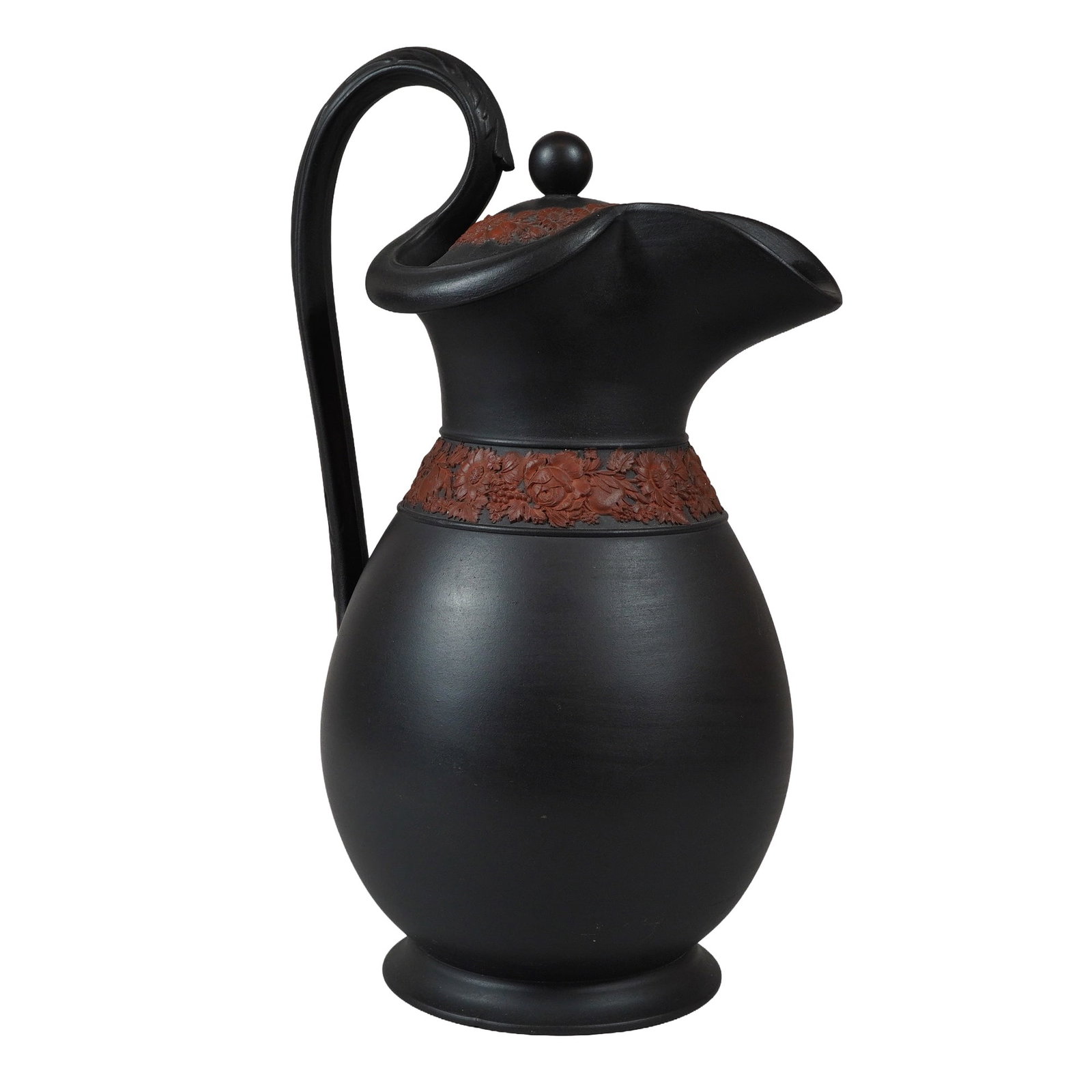 Wedgwood Black Basalt and Rosso Antico Lidded Pitcher: A Wedgwood black basalt stoneware lidded pitcher featuring a bulbous body, waisted neck, and wide flared spout. The vessel is designed with a tall, arched handle. It is decorated with a sprigged flora