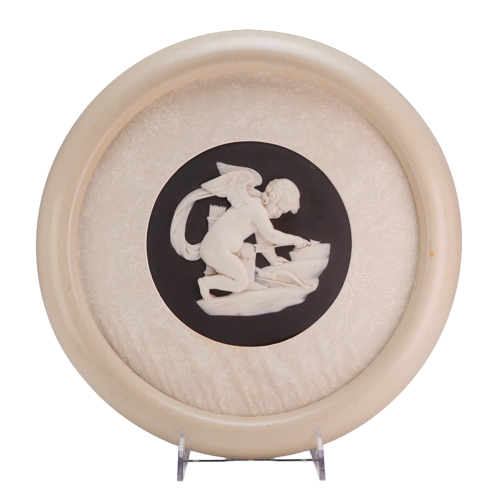 Wedgwood Framed Circular Black Jasperware Plaque, Cupid Sharpening His Arrows: This circular Wedgwood jasperware medallion features a neoclassical sprigged bas-relief scene titled Cupid Sharpening His Arrows. The plaque is composed of white stoneware relief figures applied to a 