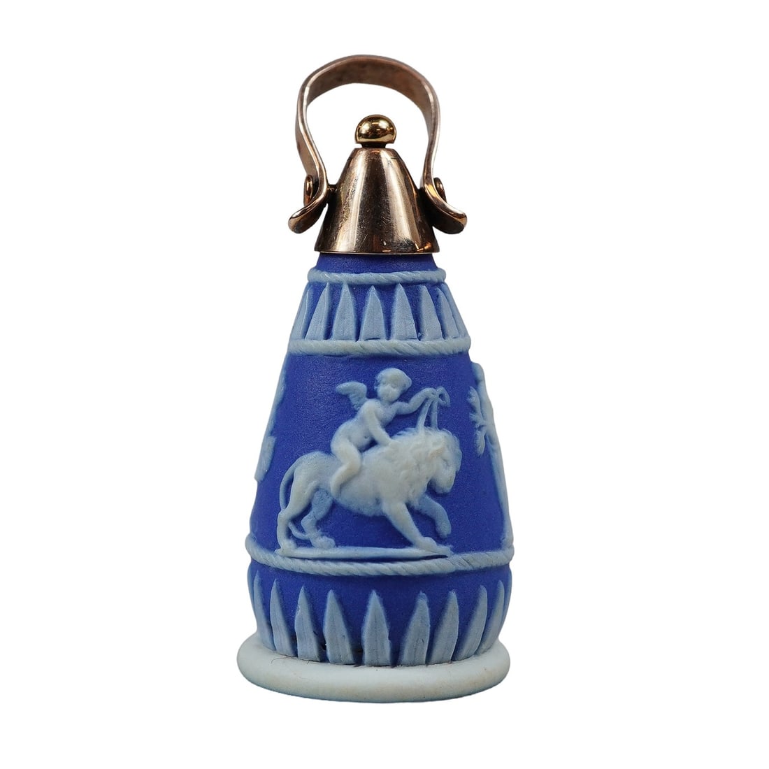 Wedgwood Jasperware Seal Pendant with Gold Plated Mounts: A miniature Wedgwood jasperware pendant of tapered, teardrop form. The body is executed in cobalt blue jasper dip and ornamented with finely detailed white bas-relief classical vignettes. One side dep
