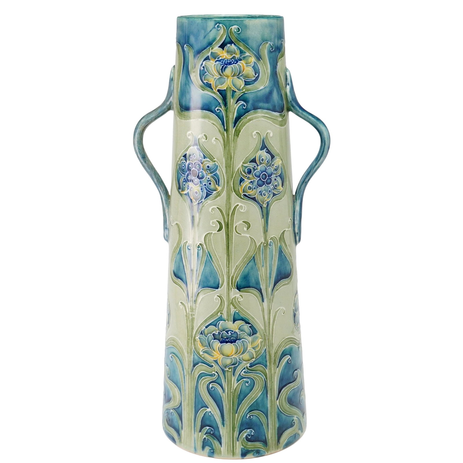 Moorcroft Pottery for Liberty and Co. Florian Ware Large Double-Handle Vase: This Art Nouveau period earthenware vessel was designed by William Moorcroft and features the Florian Ware pattern. The form is a tall, tapered cylindrical vase with two small, stylized loop handles p
