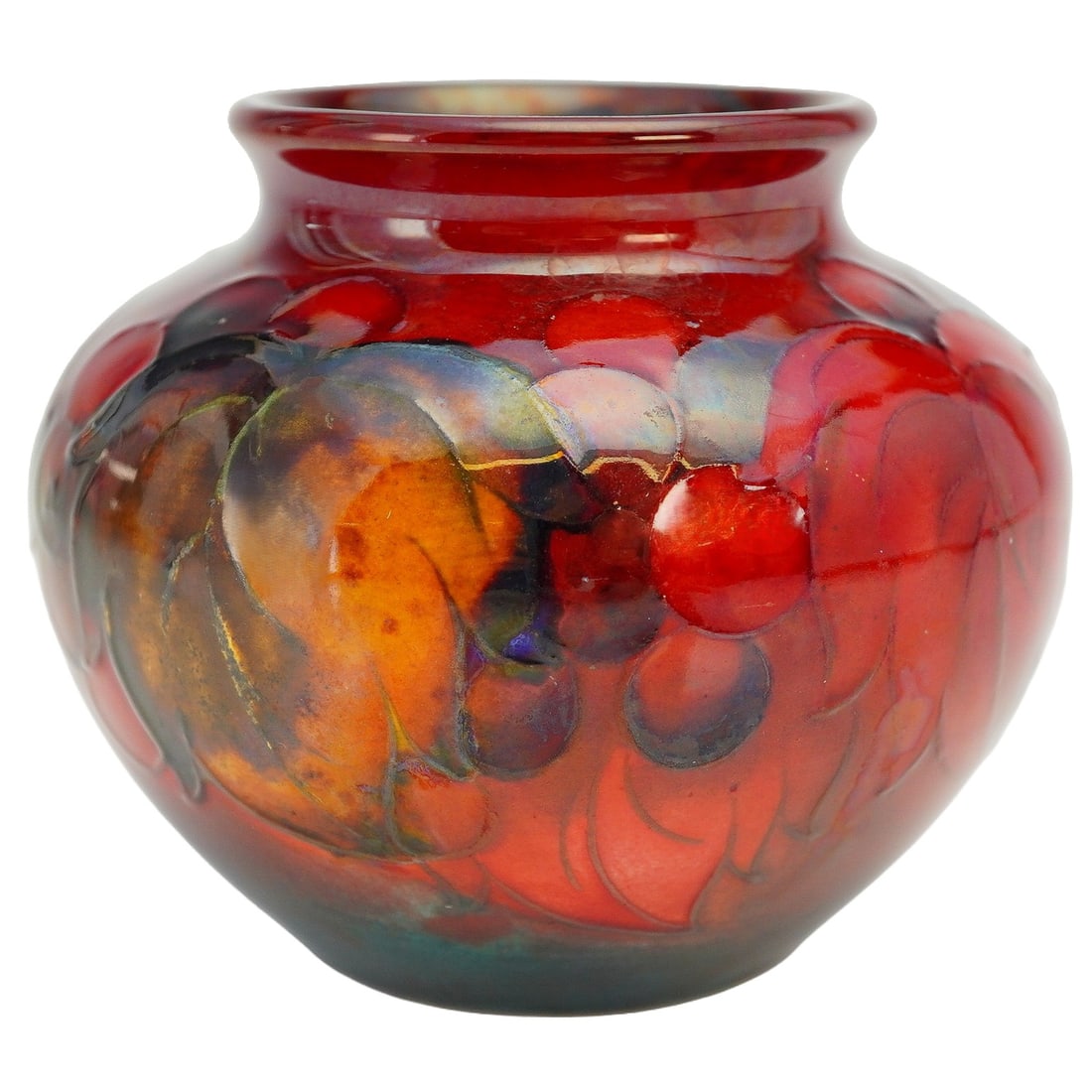 Moorcroft Pottery Small Flambe Vase, Leaf & Berry: The compact form is richly enhanced by Moorcroft's distinctive flambe glaze, creating deep, luminous red tones that subtly graduate across the surface. The tube-lined decoration features stylized leav