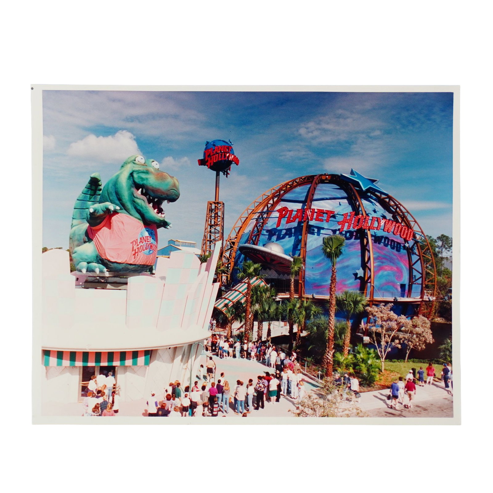 Original Walt Disney World Planet Hollywood Press Photograph: This 1995 press photo features the opening of Planet Hollywood at the Walt Disney World Resort. Dimensions: 8"L x 0.25"W x 10"H Provenance: From the estate of Ray Fisher. Weight: 0.5 oz