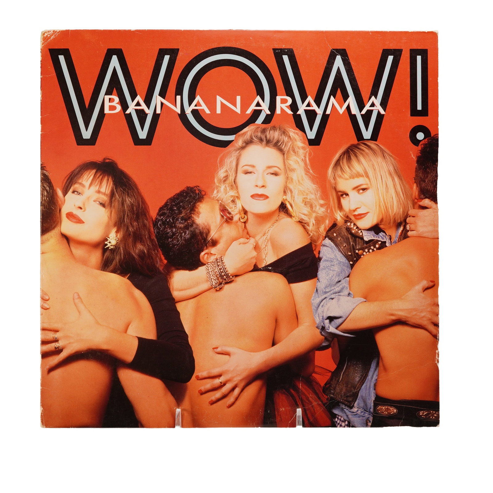Bananarama Vinyl Record, Wow!: A sizzling vinyl of Bananaramas Wow, pressed on black vinyl with a sharp cream London label, wrapped in a fiery red cover showing the trio embraced by shirtless men in bold glamorous poses, the back c