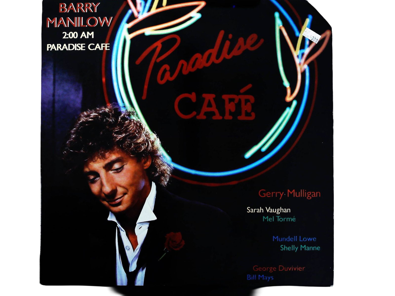 Barry Manilow 2:00 AM Paradise Cafe 1984 Arista LP: A 1984 release vinyl LP album titled 2:00 AM Paradise Cafe by Barry Manilow, released on the Arista label (Catalog No. AL8-8164). The album is a jazz-influenced work featuring collaborations with nota