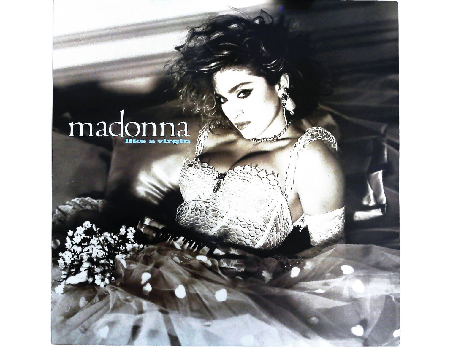 Madonna Like A Virgin Vintage Vinyl LP Album Sire Records 1-25157: A single vintage vinyl LP record album, Madonna's "Like A Virgin," released by Sire Records. The album is housed in its original printed cardboard sleeve featuring stylized black and white photography