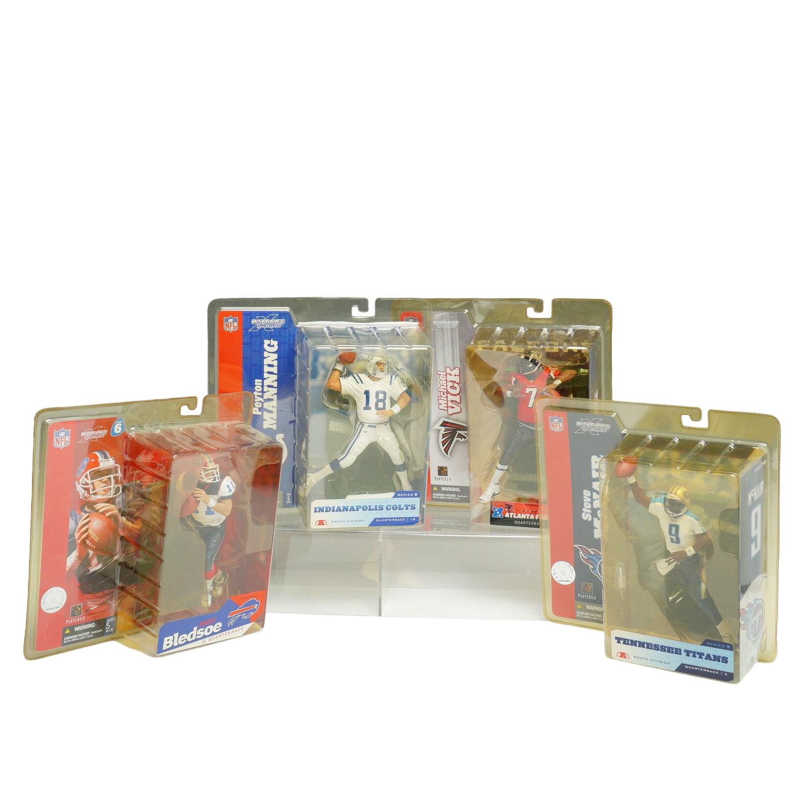 A 4pc Collection of McFarlane Toys NFL SportsPicks Action Figures: This lot features a collection of four NFL action figures produced by McFarlane Toys as part of the SportsPicks series. Each figure is depicted in an athletic pose and is housed in its original factor