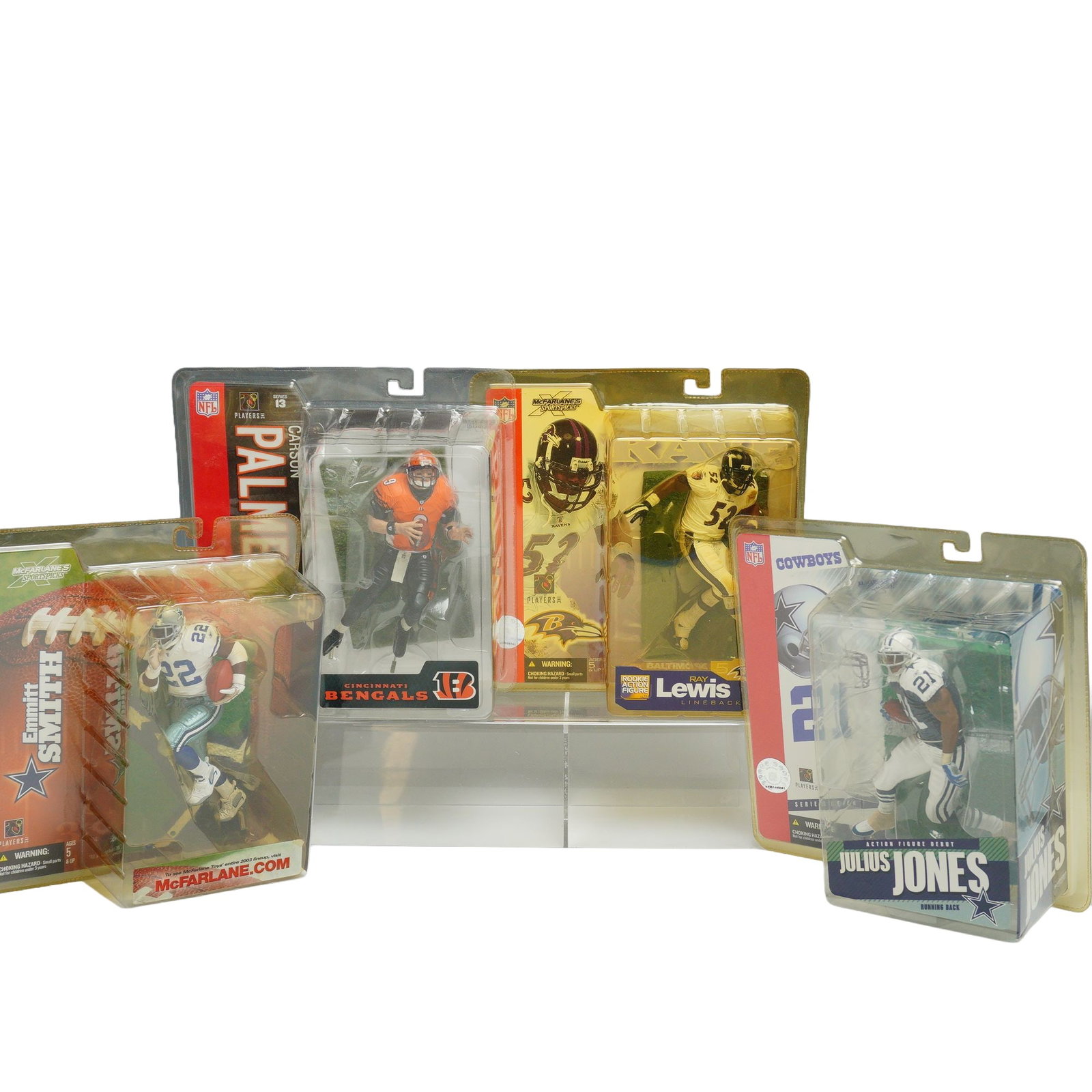 A 4pc Lot of McFarlane Toys NFL SportsPicks Action Figures: A collection of four NFL SportsPicks action figures produced by McFarlane Toys, each in its original, unopened blister pack packaging. The group includes Carson Palmer of the Cincinnati Bengals from S