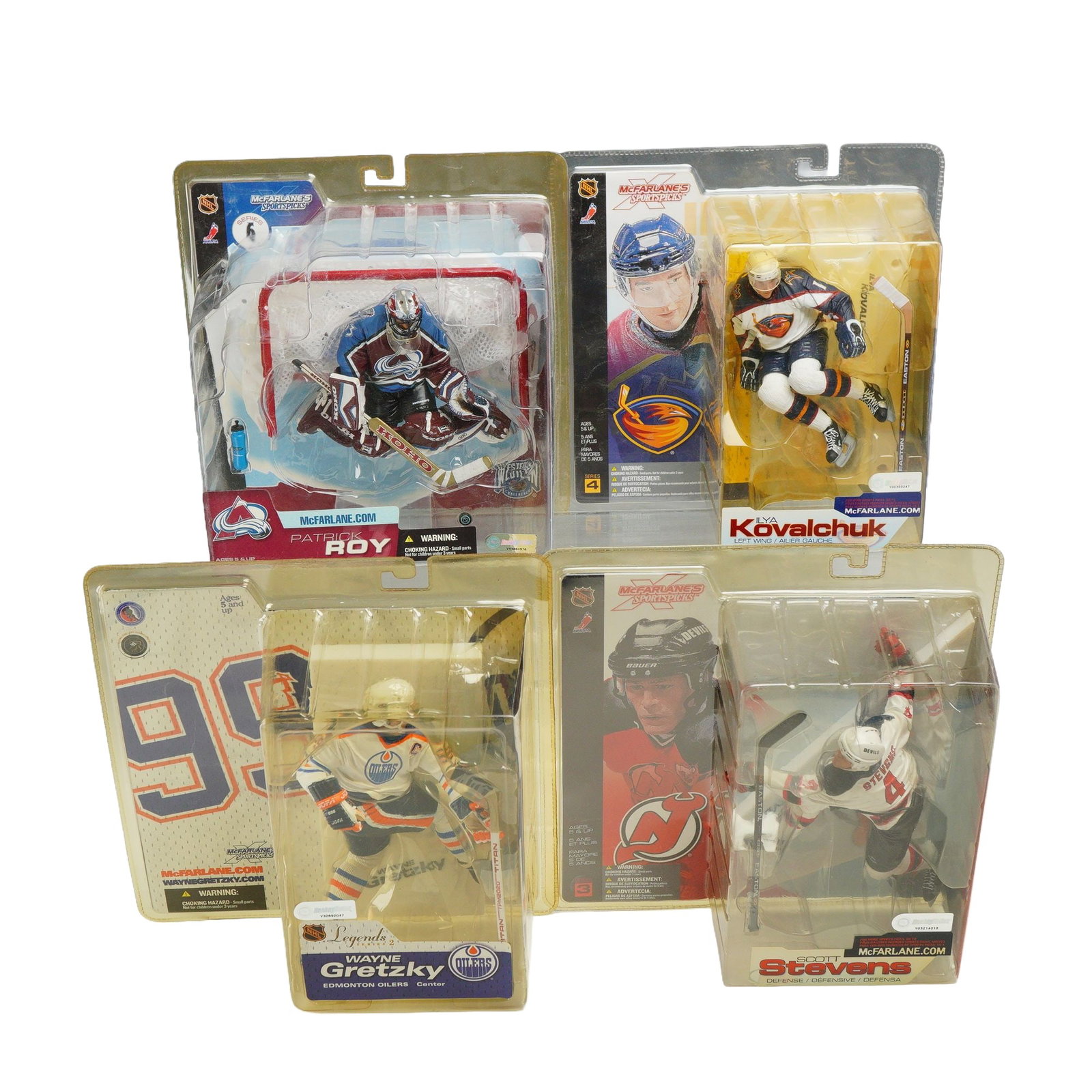 4pc McFarlane's SportsPicks NHL Hockey Action Figures in Boxes: A collection of four factory-sealed McFarlane's SportsPicks NHL action figures manufactured by McFarlane Toys. The group features prominent players from various eras and series, each presented in a dy