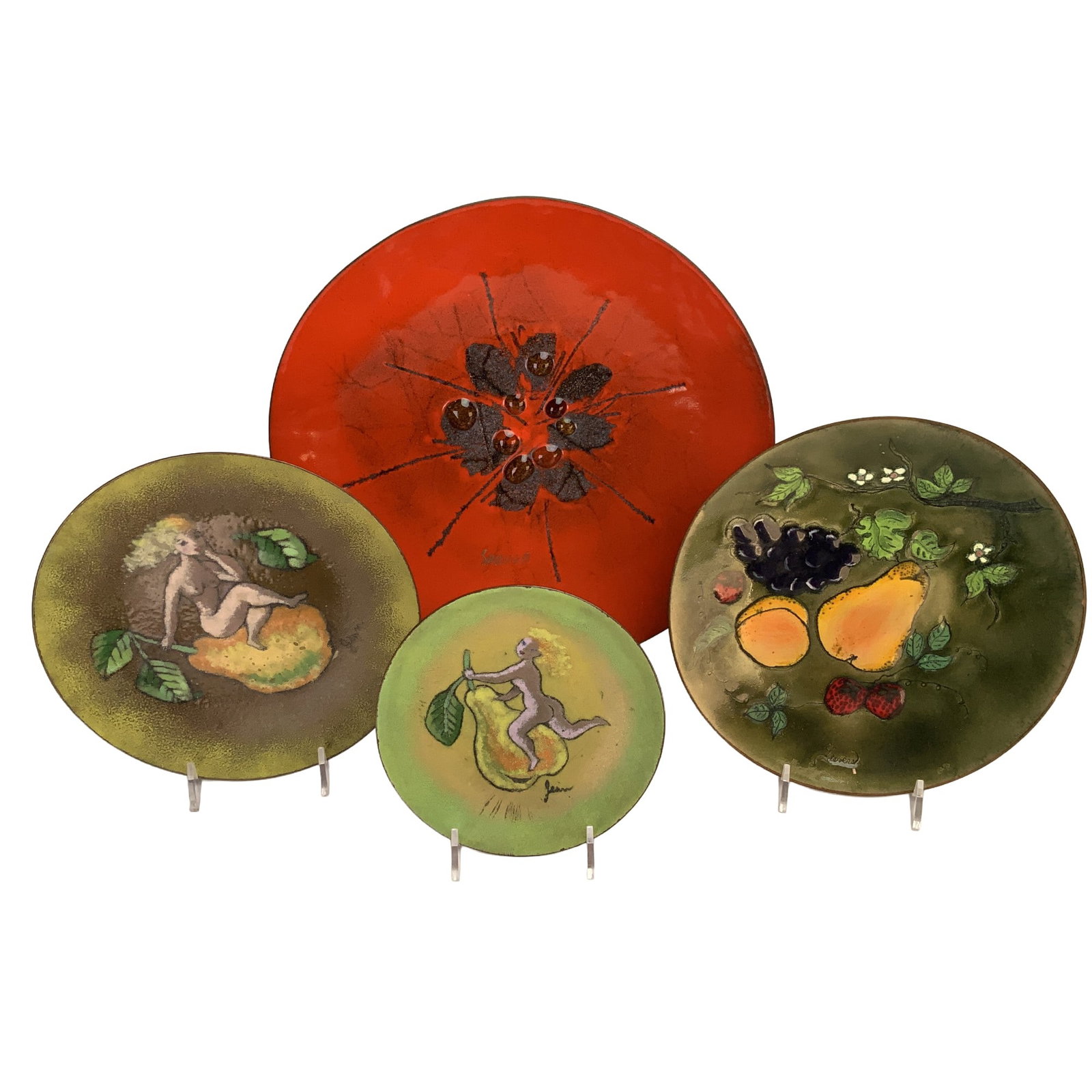 4pc Enamel on Copper Decorative Plates: This collection consists of four decorative plates and chargers featuring vitreous enamel on copper. The assortment includes a large charger with a high-gloss red field, a central black abstract burst