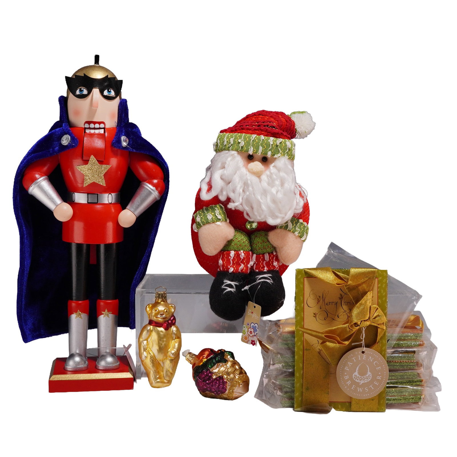 13pc Christmas Grouping Including Macy's Superhero Nutcracker and Sitting Santa Decoration: A thirteen-piece assortment of Christmas-themed decorative items and stationery. This grouping includes a Macy's superhero wooden nutcracker featuring a black mask, red suit with a gold star, and a bl