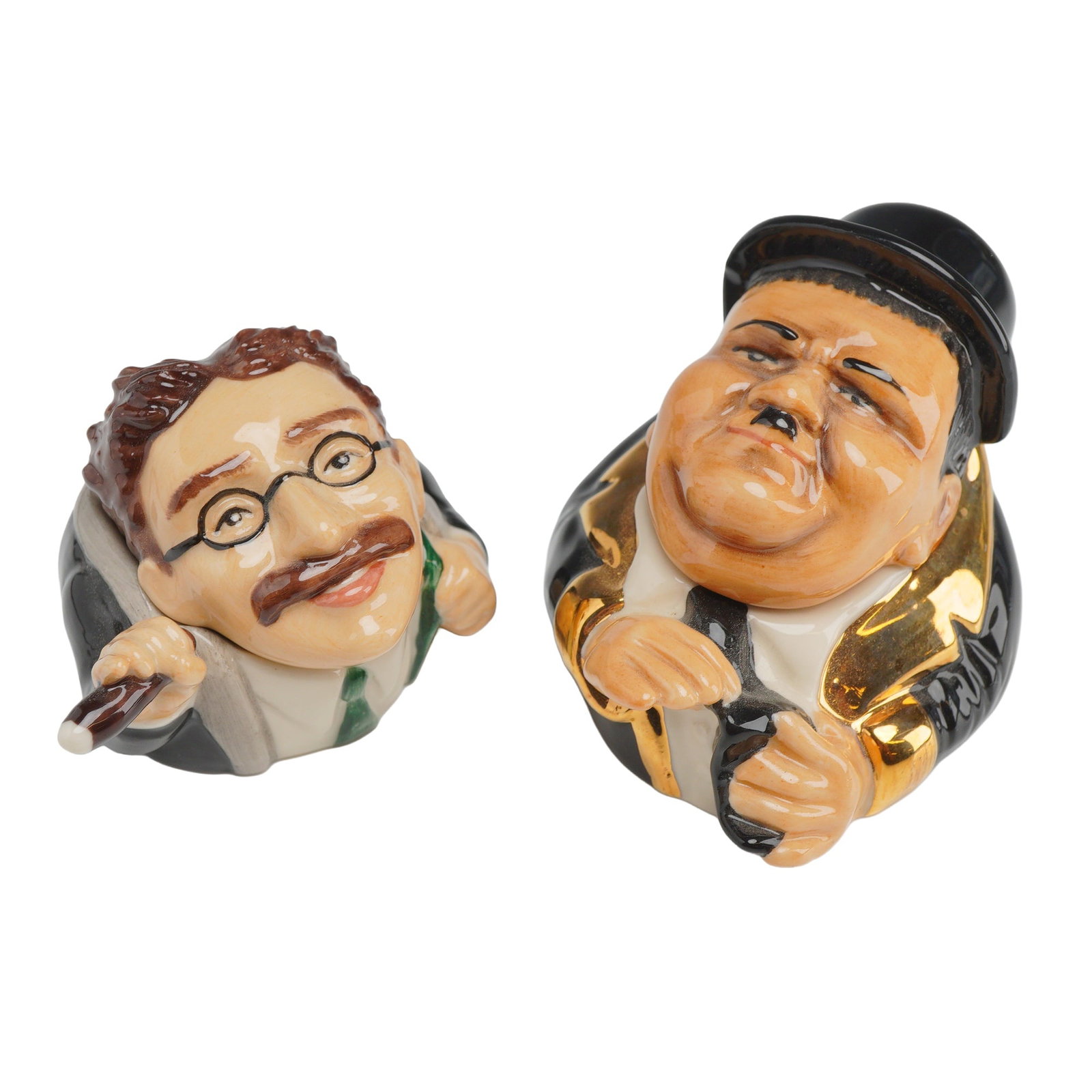 2pc Kevin Francis Face Pots, Groucho Marx and Ollie: This pair of polychrome glazed ceramic lidded character containers, known as Face Pots, features caricatures of comedians Groucho Marx and Oliver Hardy (Ollie). Produced by Kevin Francis, these collec