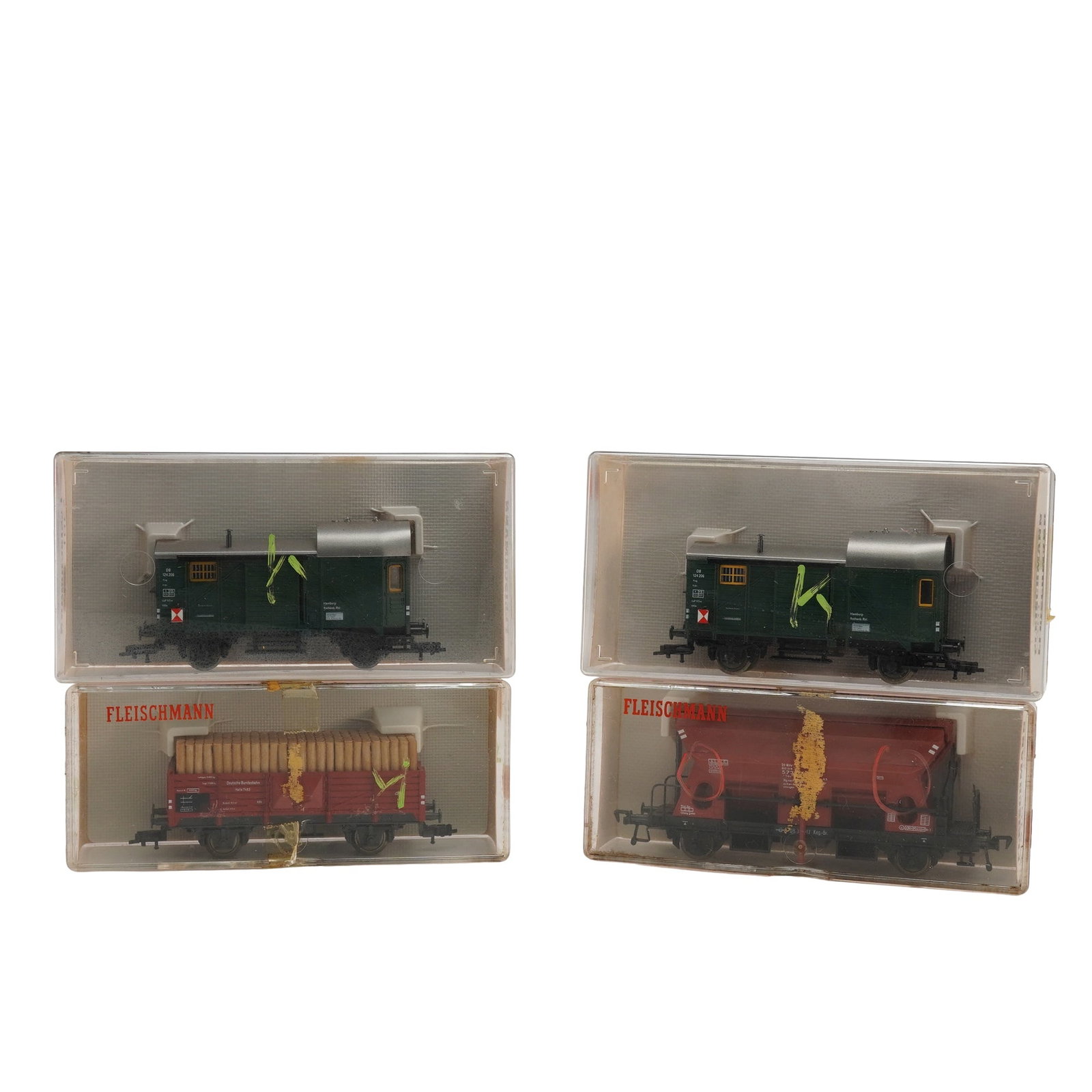 4pc Fleischmann HO Gauge Freight Cars, 5301, 5301, 5510, 5203: This lot consists of four Fleischmann HO scale freight cars, each housed in its original clear plastic case with printed inserts and red instruction panels on the reverse. The group includes two model