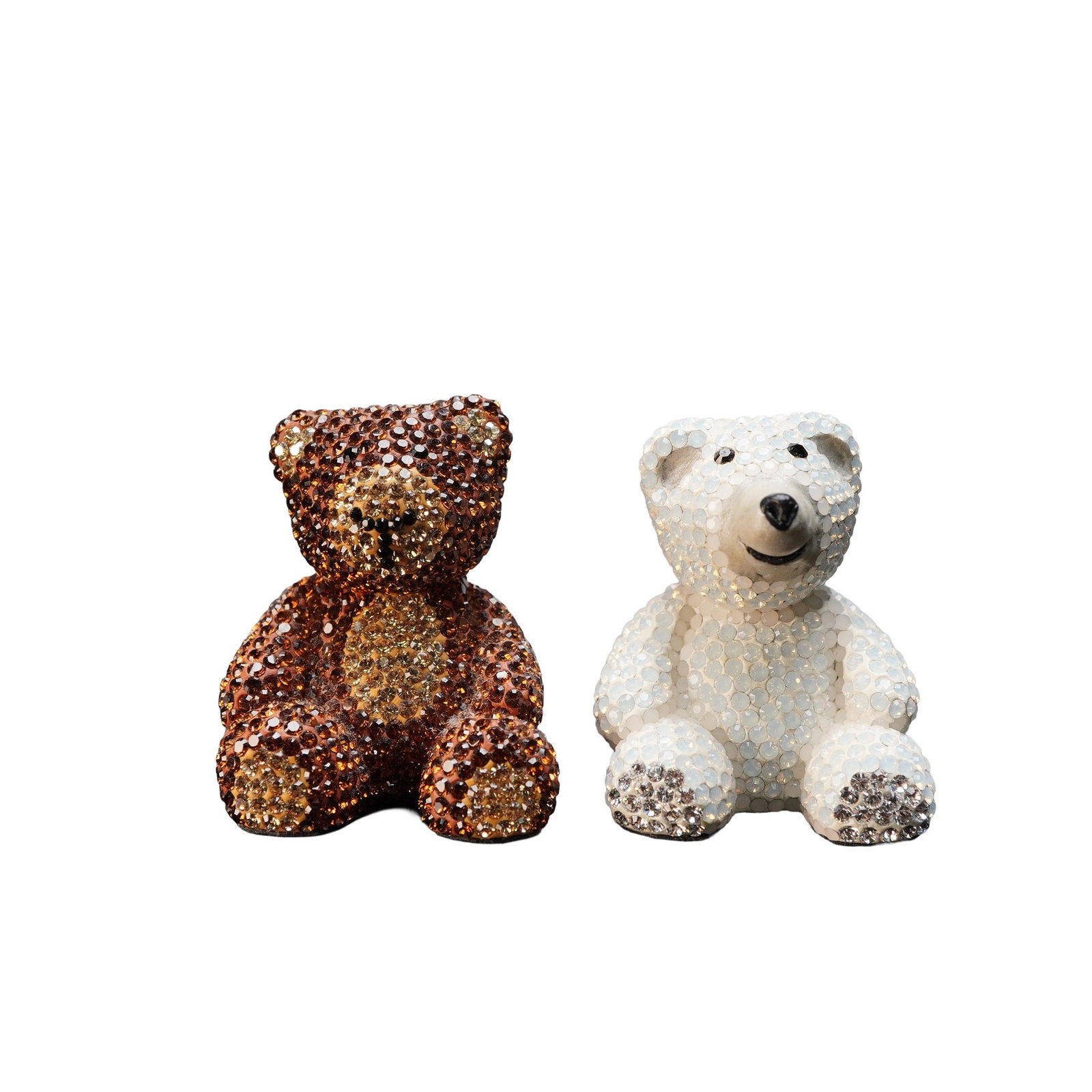 2pc Crystal-Encrusted Teddy Bear Figurines: A charming pair of sparkling teddy bear figurines, each fully encrusted with shimmering crystals. One bear features a warm amber-brown tone, while the other is finished in icy white with a cheerful ex