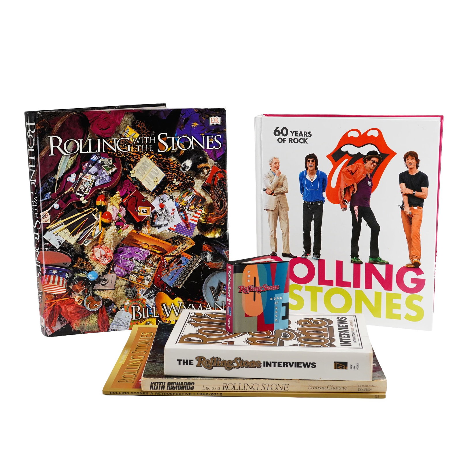 6pc Collection of Rolling Stones Hardcover and Softcover Books, Magazine and Pocket Book of Love: A 6pc collection of books and magazines focused on the rock band The Rolling Stones. The assortment includes several hardcover volumes and commemorative printed materials: Wyman, Bill. Rolling with th