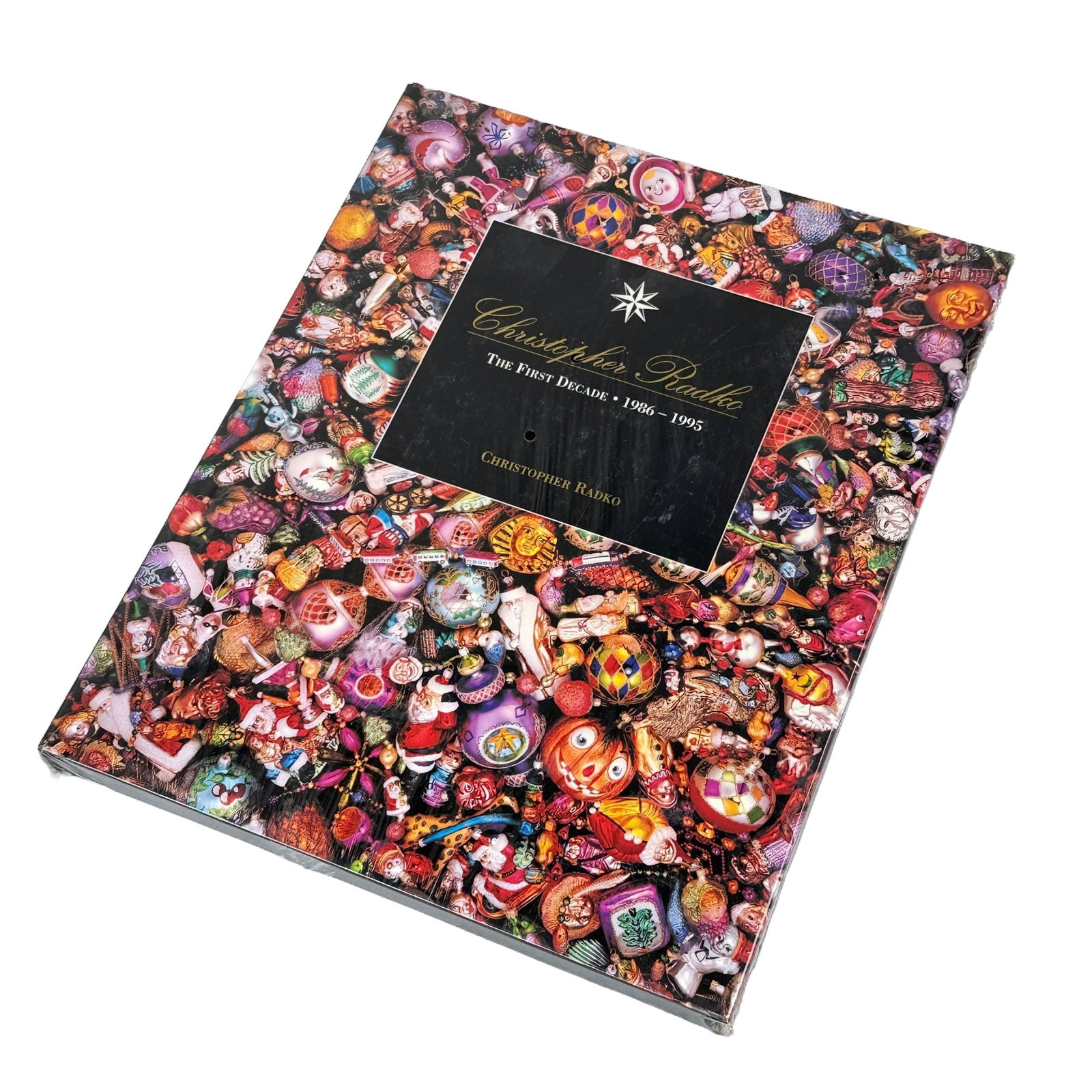 Radko, Christopher. Christopher Radko: The First Decade, 1986-1995. Starad Inc., 1995.: This large-format hardcover coffee table book, titled Christopher Radko: The First Decade, 1986-1995, serves as a comprehensive visual record of the artist's ornament designs during his initial ten ye