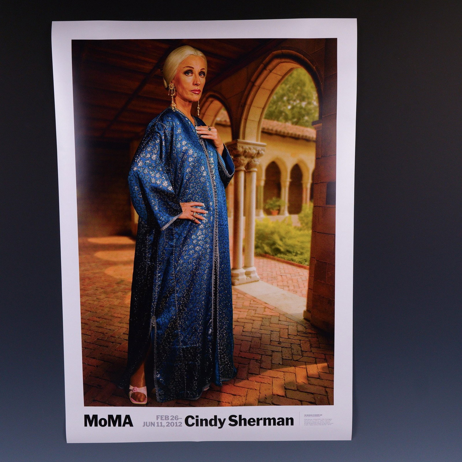 Cindy Sherman 2012 MoMA Exhibition Poster w/ Untitled #466: A striking original exhibition poster from the Museum of Modern Art (MoMA), featuring Untitled #466 by the renowned American artist Cindy Sherman. This chromogenic color print depicts Sherman in one o