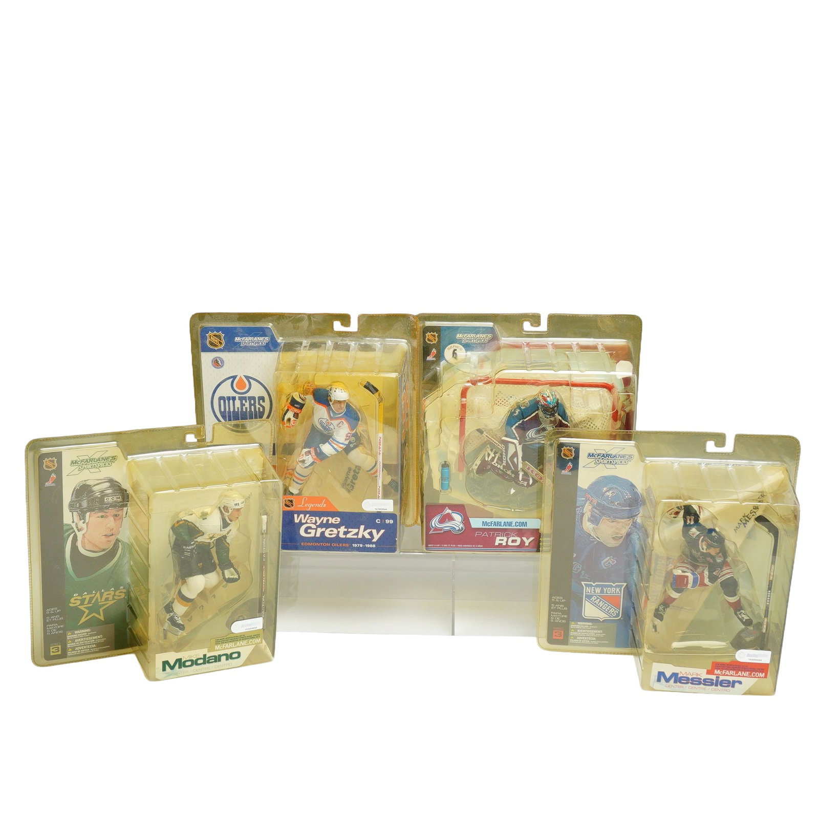 A Set of 4 McFarlane Toys NHL Sportspicks Hockey Action Figures: This set of four NHL hockey action figures is produced by McFarlane Toys as part of the McFarlane's Sportspicks product line. Each figure is presented in its original, unopened blister pack packaging.