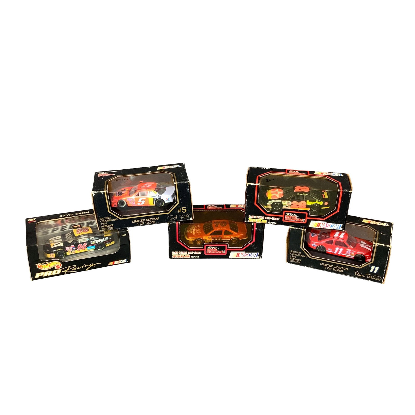 Five 1:43 Scale NASCAR Die-Cast Model Cars Including Hot Wheels and Racing Champions: A collection of five 1:43 scale NASCAR die-cast model cars in original display packaging, featuring manufacturers Racing Champions and Hot Wheels PRO Racing. The lot includes a David Green number 96 C