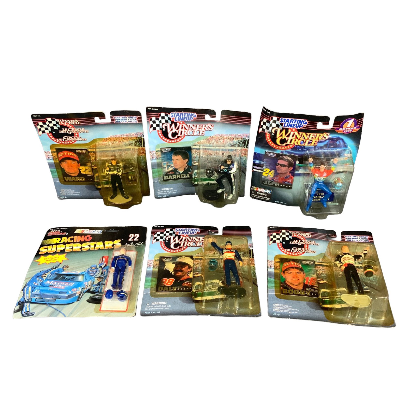 Assortment of Six Winners Circle and Racing Champions NASCAR Driver Action Figures: This collection features six vintage NASCAR driver action figures from the 1990s, each preserved in its original factory blister packaging. The group includes five figures from the Winner's Circle and