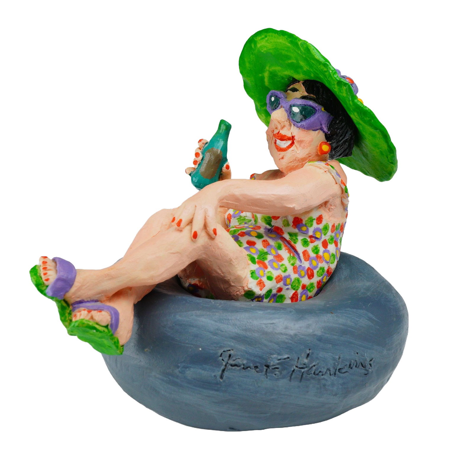 Jane F. Hawkins Clay Sculpture of a Woman in an Inner Tube: This hand-molded and hand-painted clay sculpture by artist Jane F. Hawkins depicts a flamboyantly dressed woman in an inner tube float with a drink in her hand. The piece features a two-piece construc