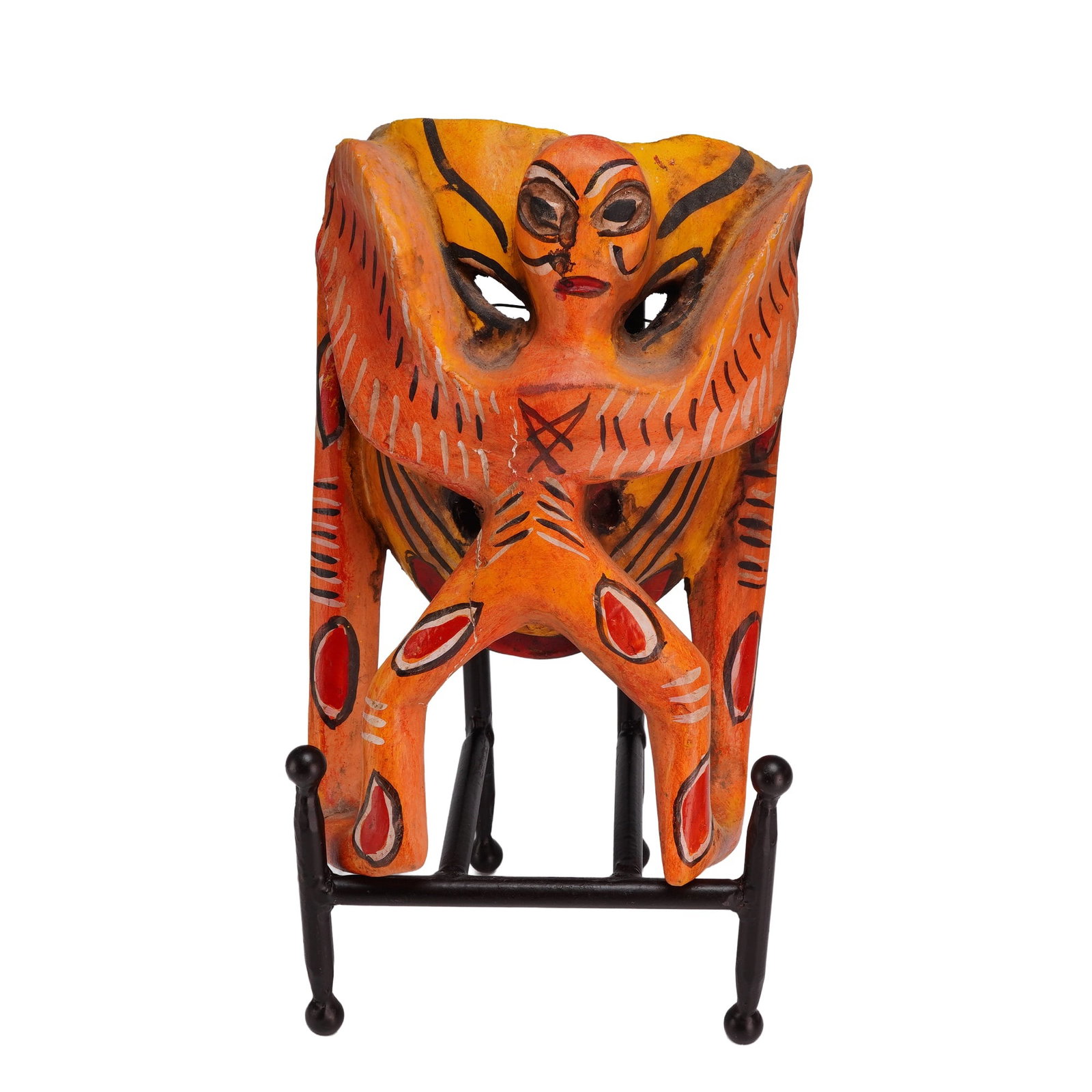Mexican Guerrero-Style Polychrome Carved Wood Mask: This hand-carved wood mask is attributed to the Guerrero region of Mexico, representing the region's traditional polychrome folk art. The object features a central winged human figure carved in high r