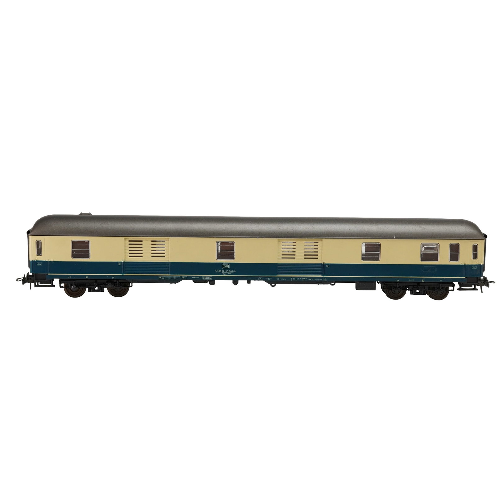 Roco HO Scale Passenger Car Model 4259: This Roco HO scale model 4259 features a detailed passenger car with a tan and blue color scheme. The car includes finely molded components and is marked Made in Austria on the underside, highlighting