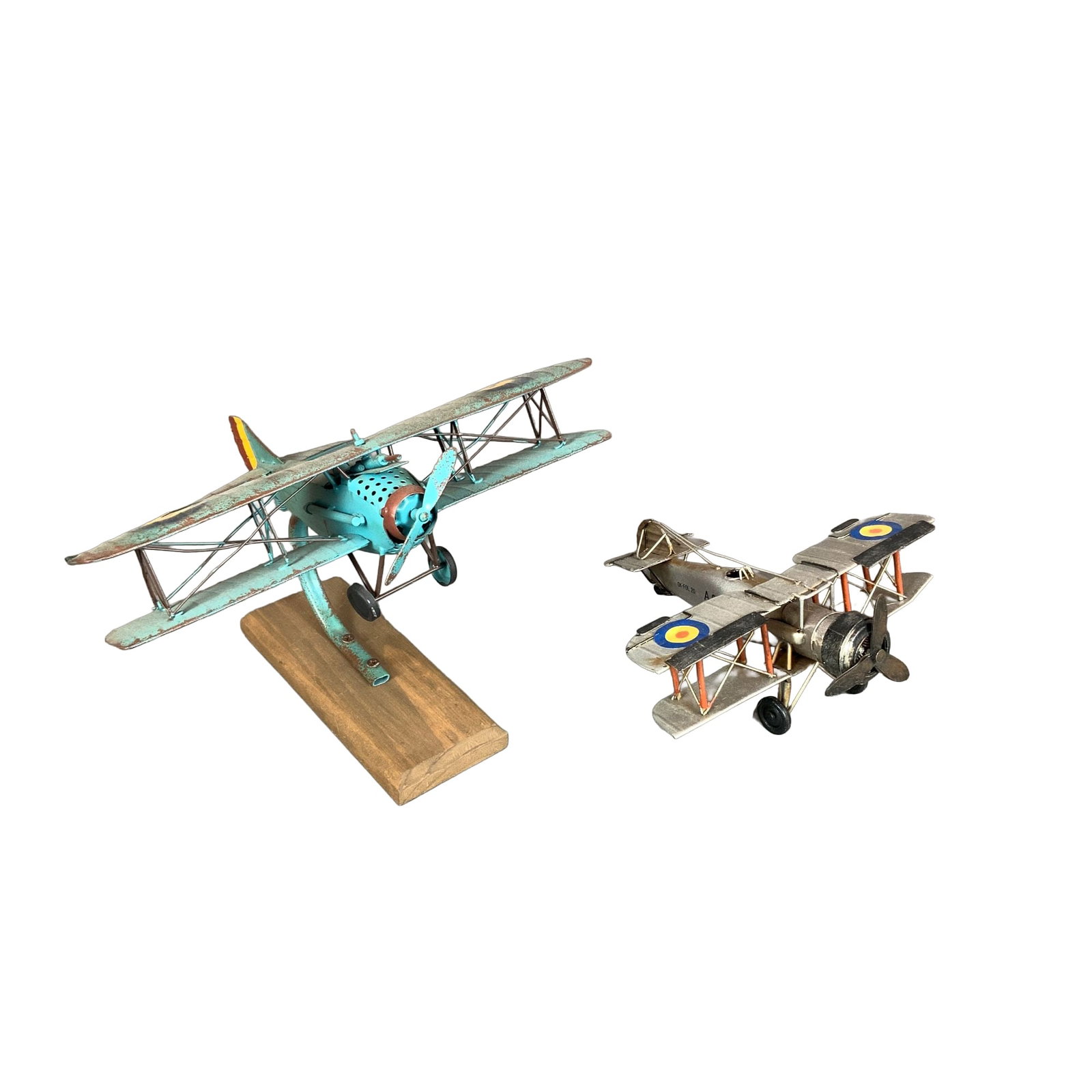 2pc British Royal Air Force Style Biplane Aircraft Models: This lot consists of a pair of British Airforce style aircraft models, constructed from painted sheet metal and designed as contemporary decorative collectibles with a vintage aesthetic. These items a