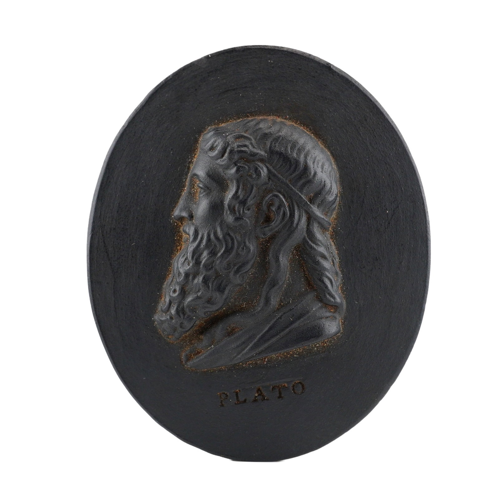Wedgwood Black Basalt Portrait Medallion of Plato: This oval portrait medallion is crafted from Wedgwood black basalt, a fine-grained, unglazed matte black stoneware. The obverse features a high-relief profile bust of the Greek philosopher Plato, faci