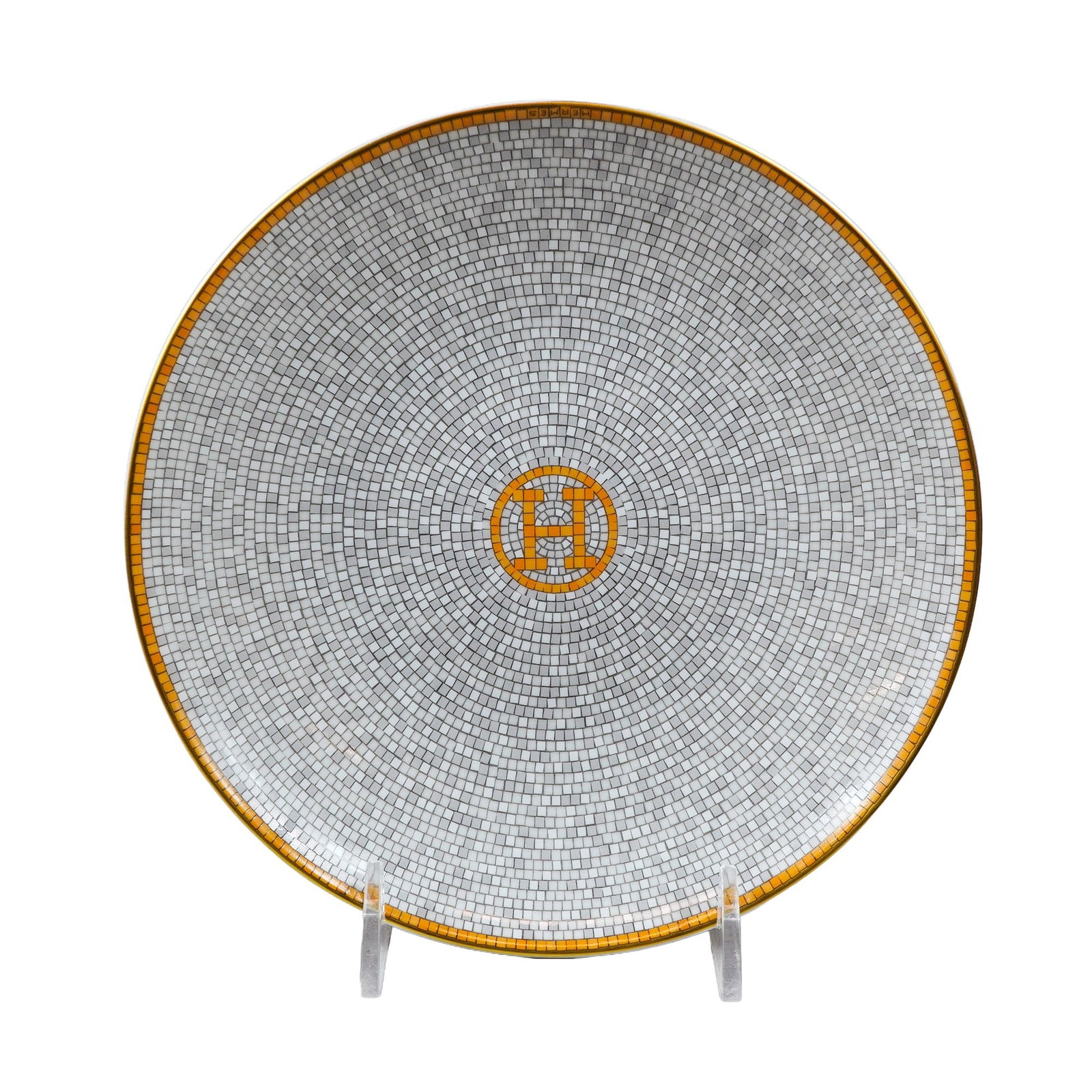 Hermes Mosaique au 24 Gold Porcelain Bread and Butter Plate: Hermes (Paris) porcelain plate from the Mosaique au 24 collection. The circular form features a geometric mosaic pattern of small grey and white tiles arranged in concentric circles. A central H emble
