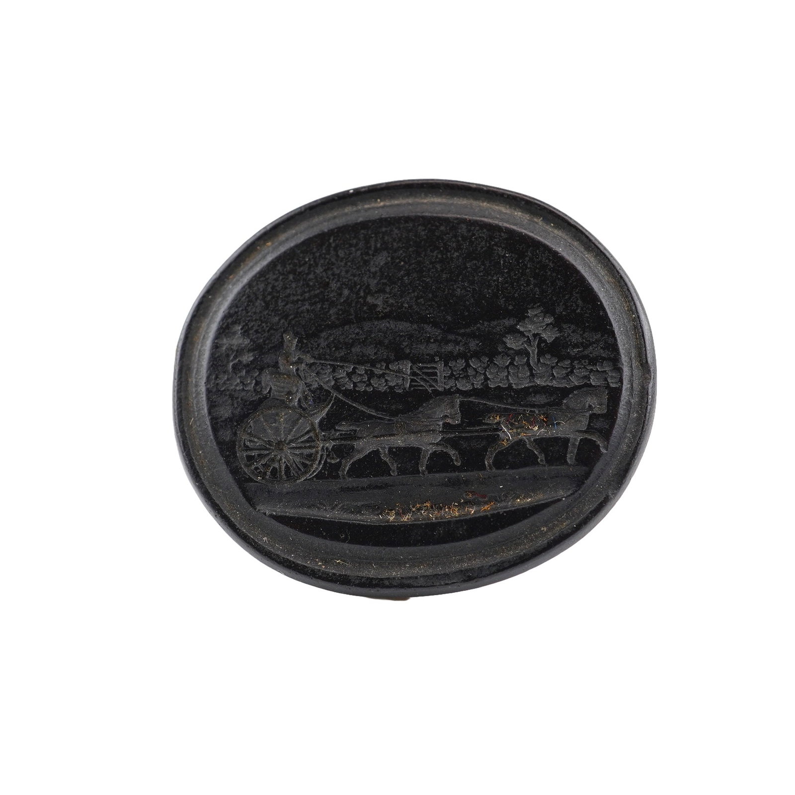 Wedgwood Oval Black Basalt Intaglio Medallion: This oval medallion is crafted from black basalt, a fine-grained, unglazed stoneware developed by Josiah Wedgwood. The face of the piece features an incised intaglio scene depicting a driver in a two-