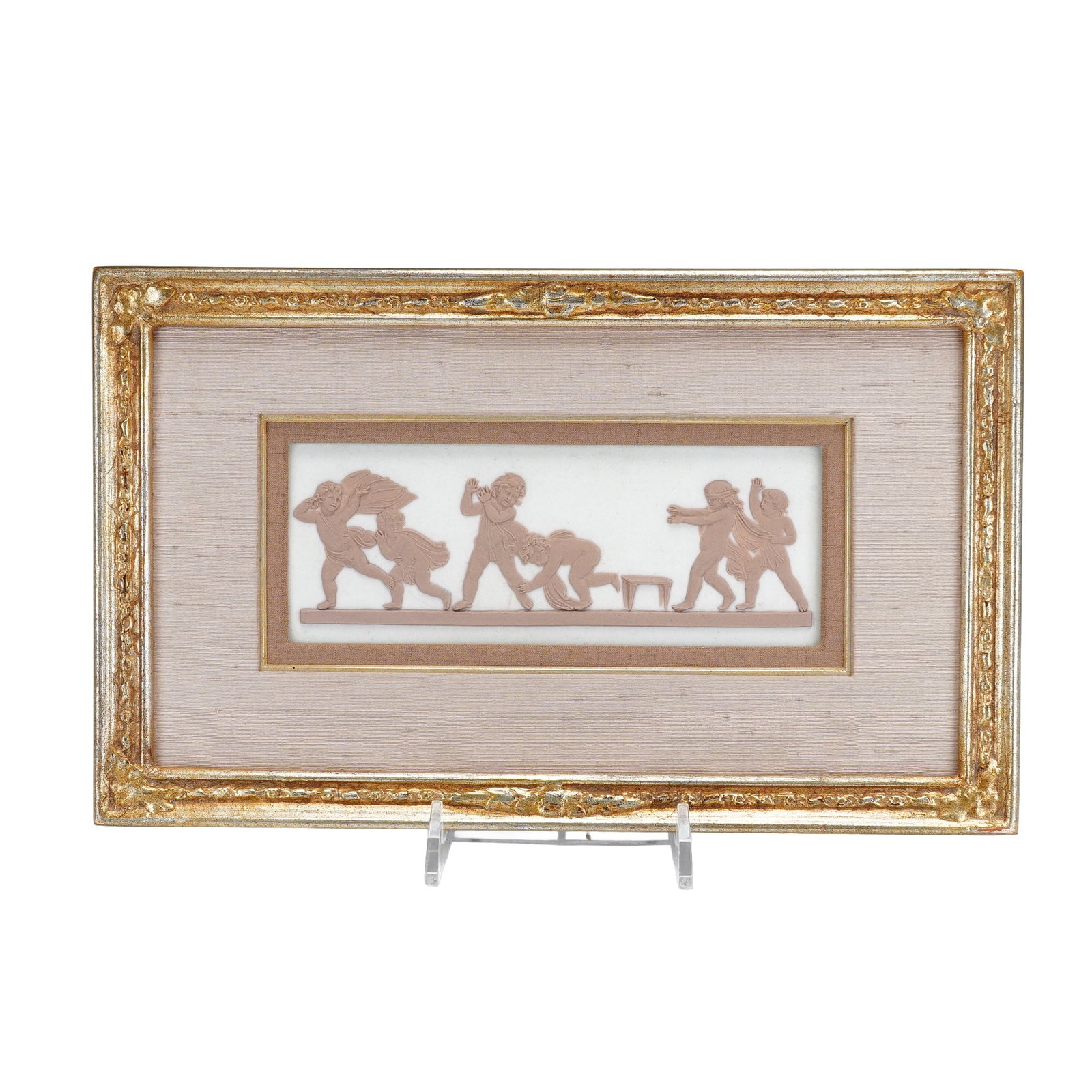 Framed Wedgwood Jasperware Plaque: A rectangular Wedgwood jasperware plaque featuring a classical relief scene of putti or cherubs. The figures are executed in terracotta-colored stoneware applied to a white ground, depicted in various
